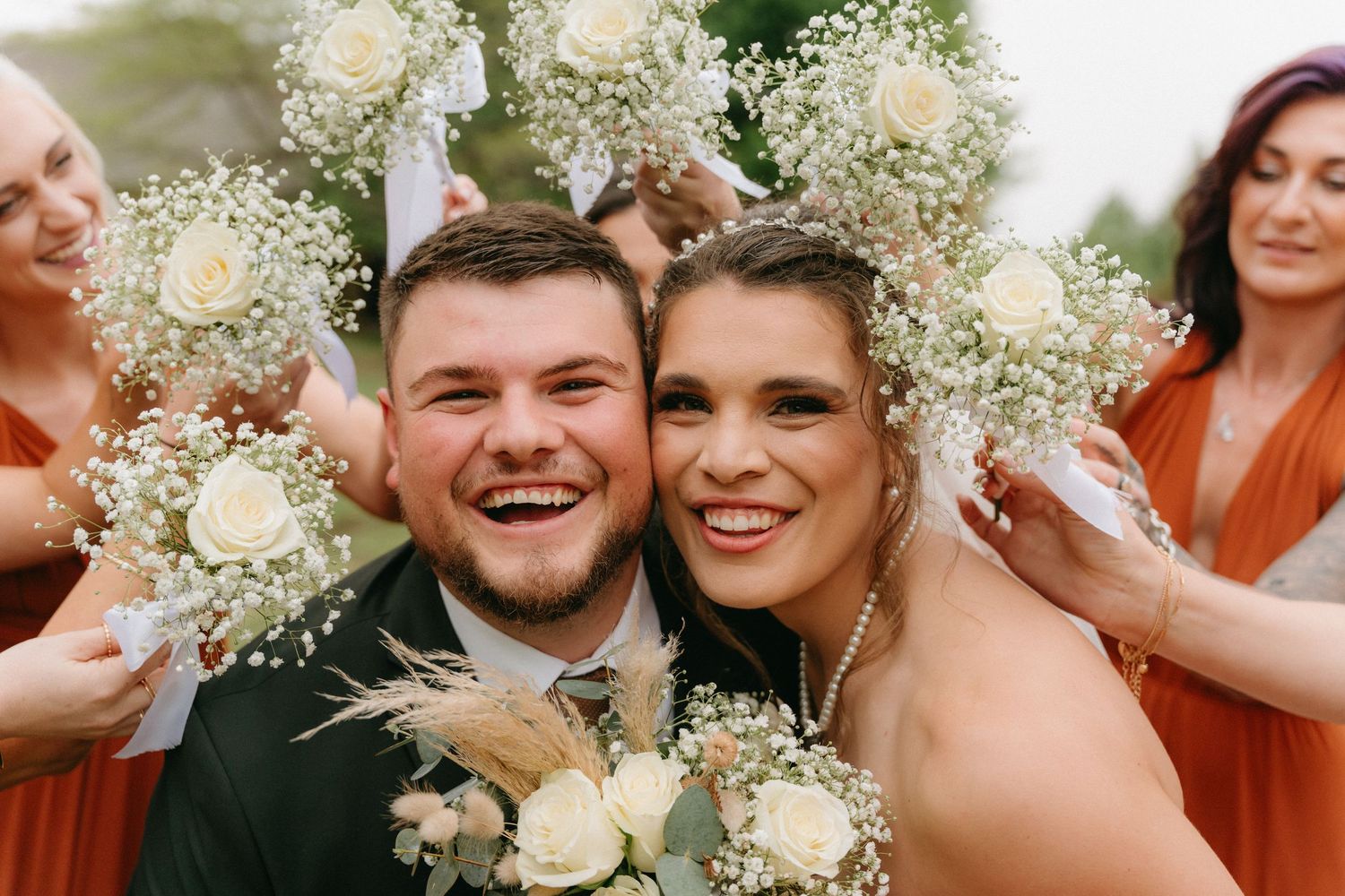 Couple laughing during rainy outdoor photoshoot at La La Nathi