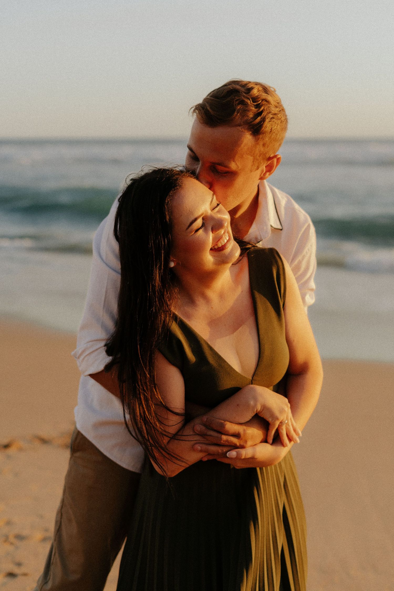 A couple shares intimate moments during sunset at the beach, embracing each other in a series of romantic poses.