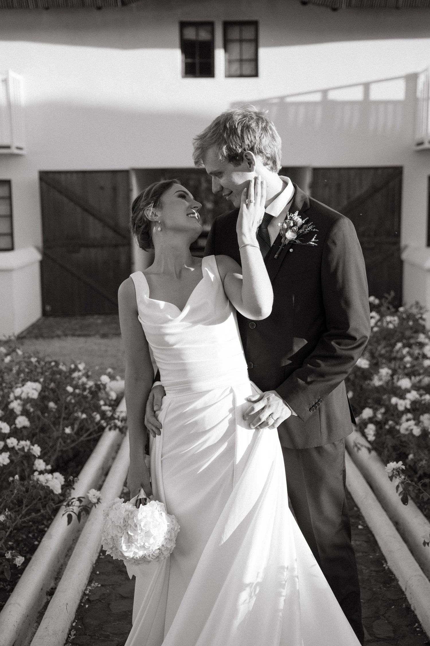 A sequence of black and white wedding photos showing intimate moments between a bride in white and groom in dark attire.