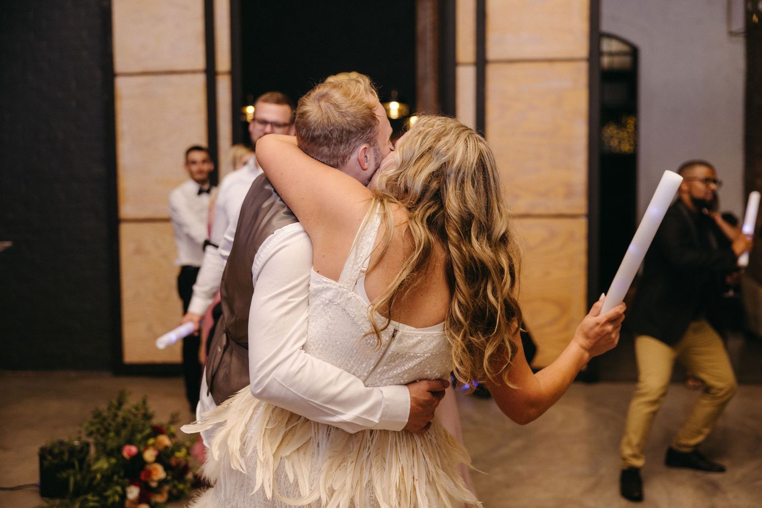 A couple embraces on the dance floor during their wedding celebration.