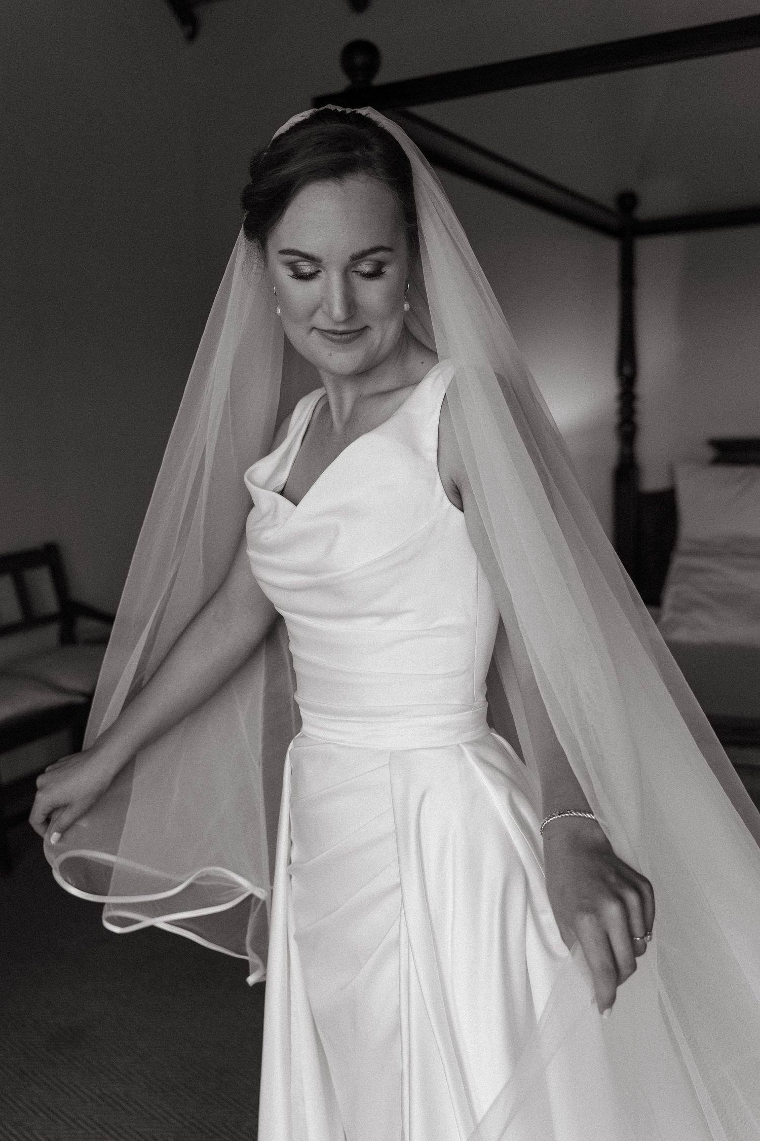 Black and white detail shots of an elegant white wedding dress with flowing fabric and veil.