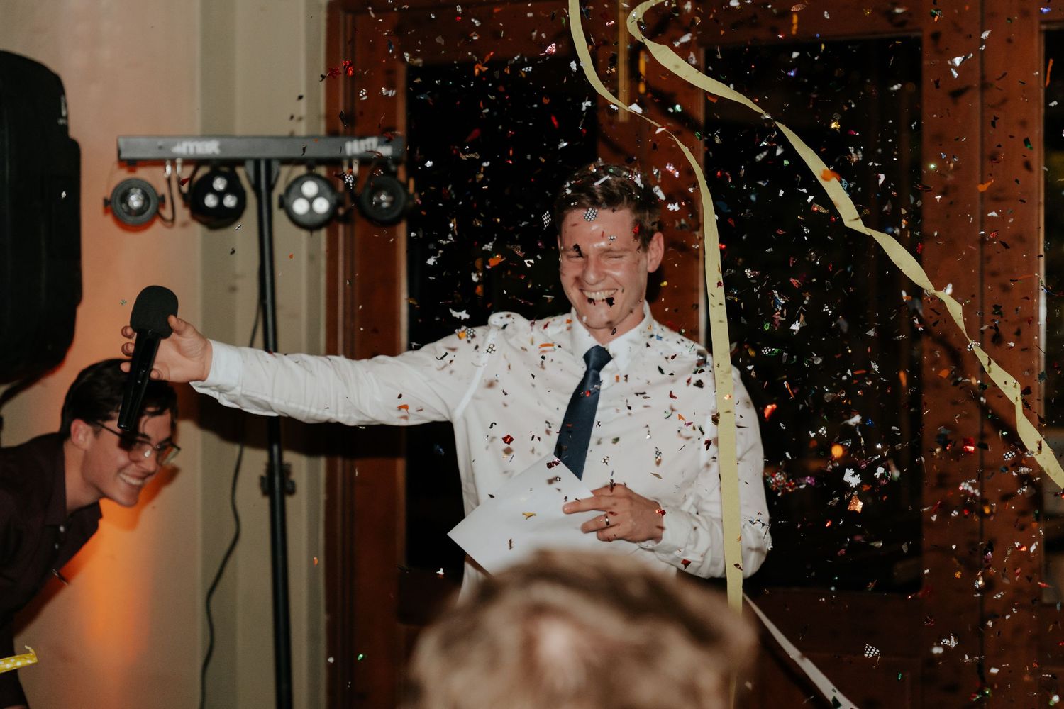 Wedding reception scene with sparklers creating magical light trails as guests celebrate the newlyweds.