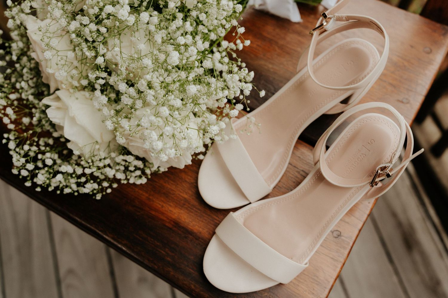 Wedding details featuring delicate baby's breath bouquet and blush pink heels.
