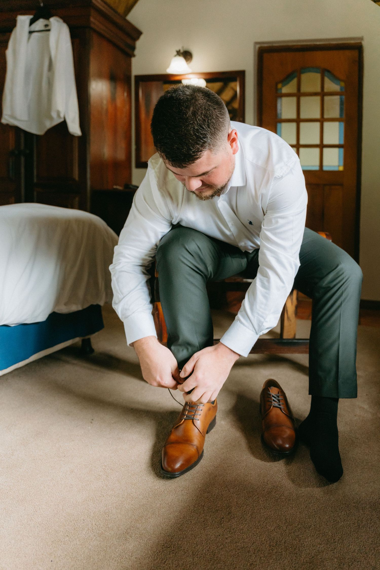 Series of photos showing someone putting on brown leather dress shoes while getting ready.
