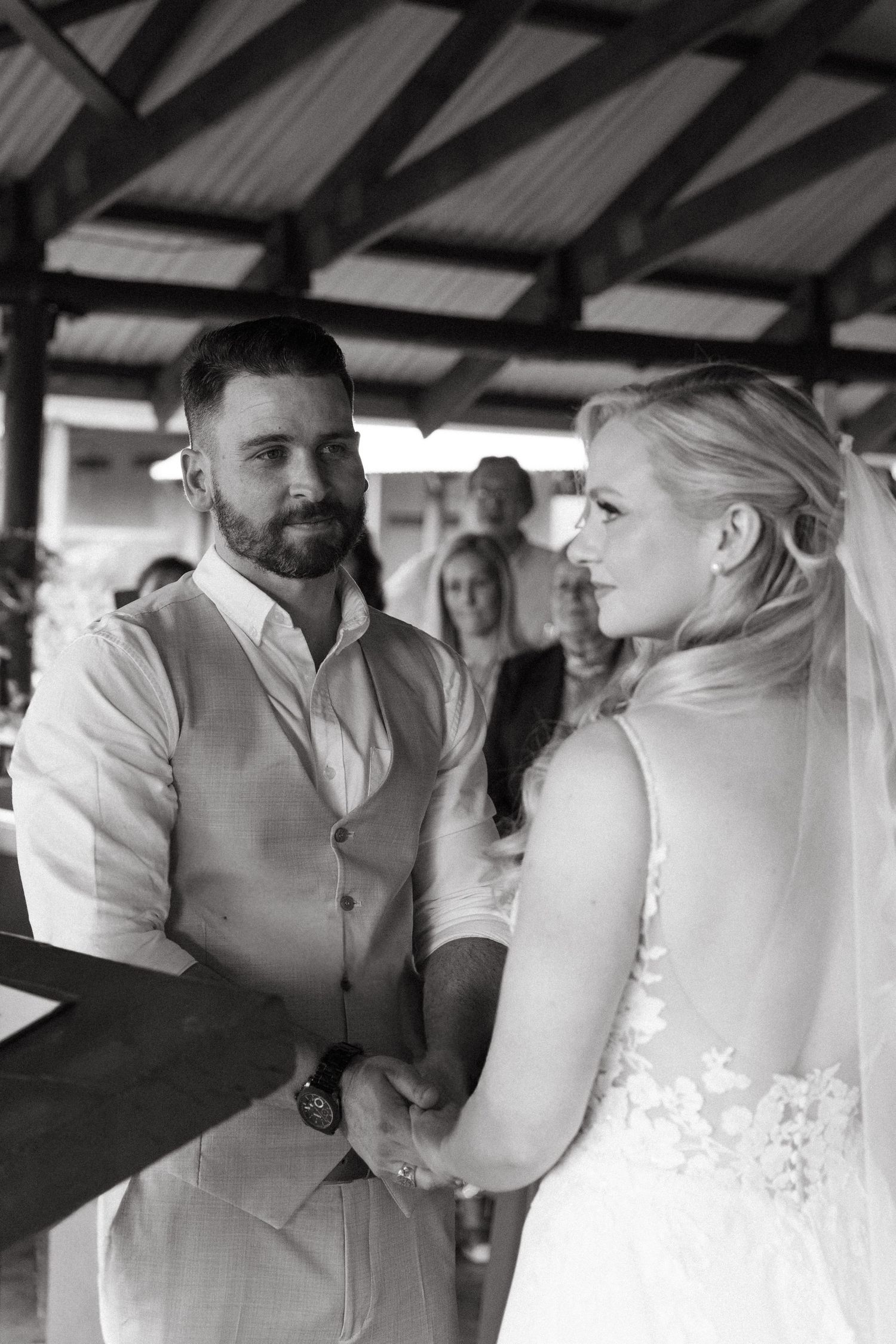 Intimate wedding ceremony moments captured under rustic covered pavilion.