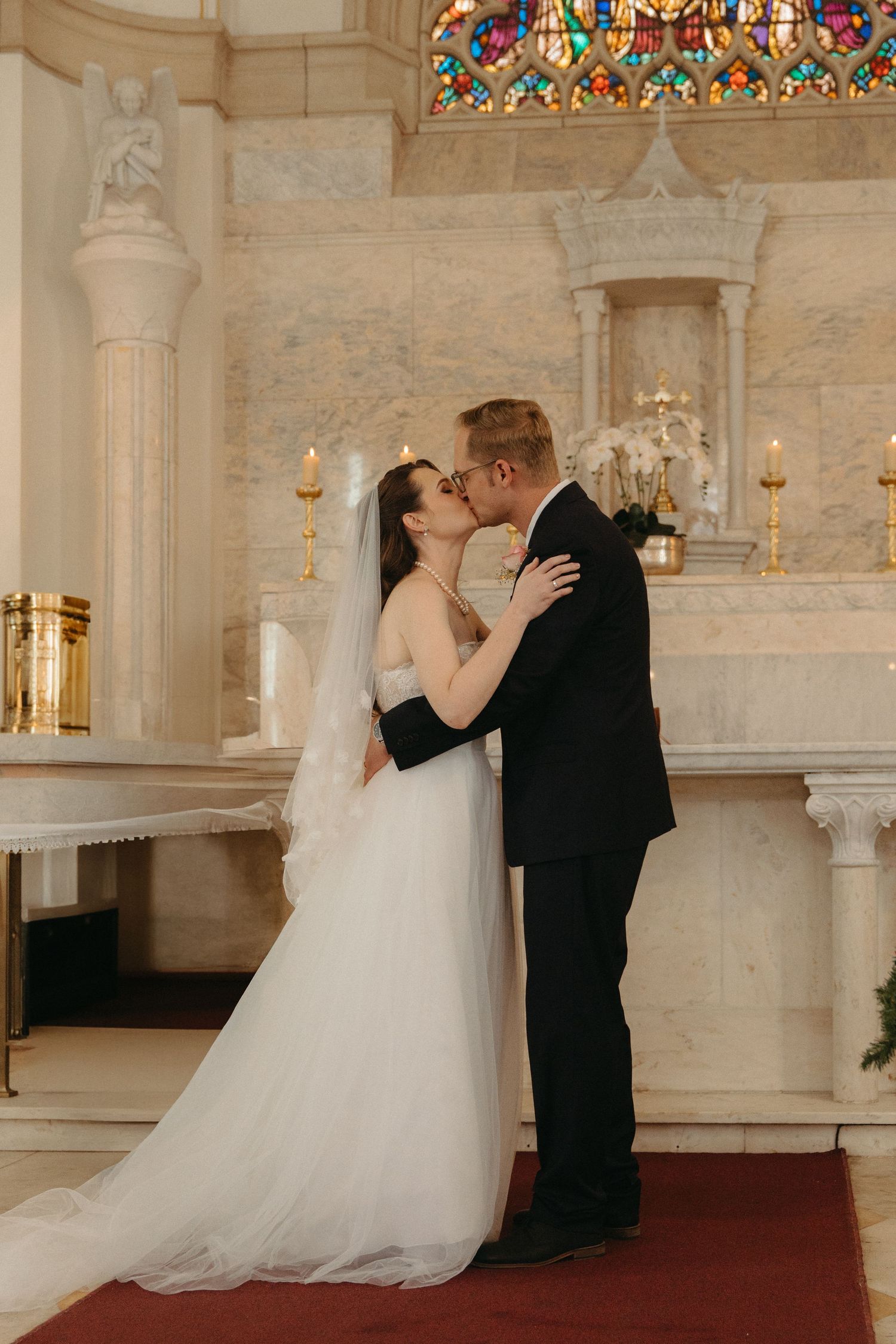 A romantic wedding ceremony sequence showing a couple sharing their first kiss at the altar in a beautiful church setting.