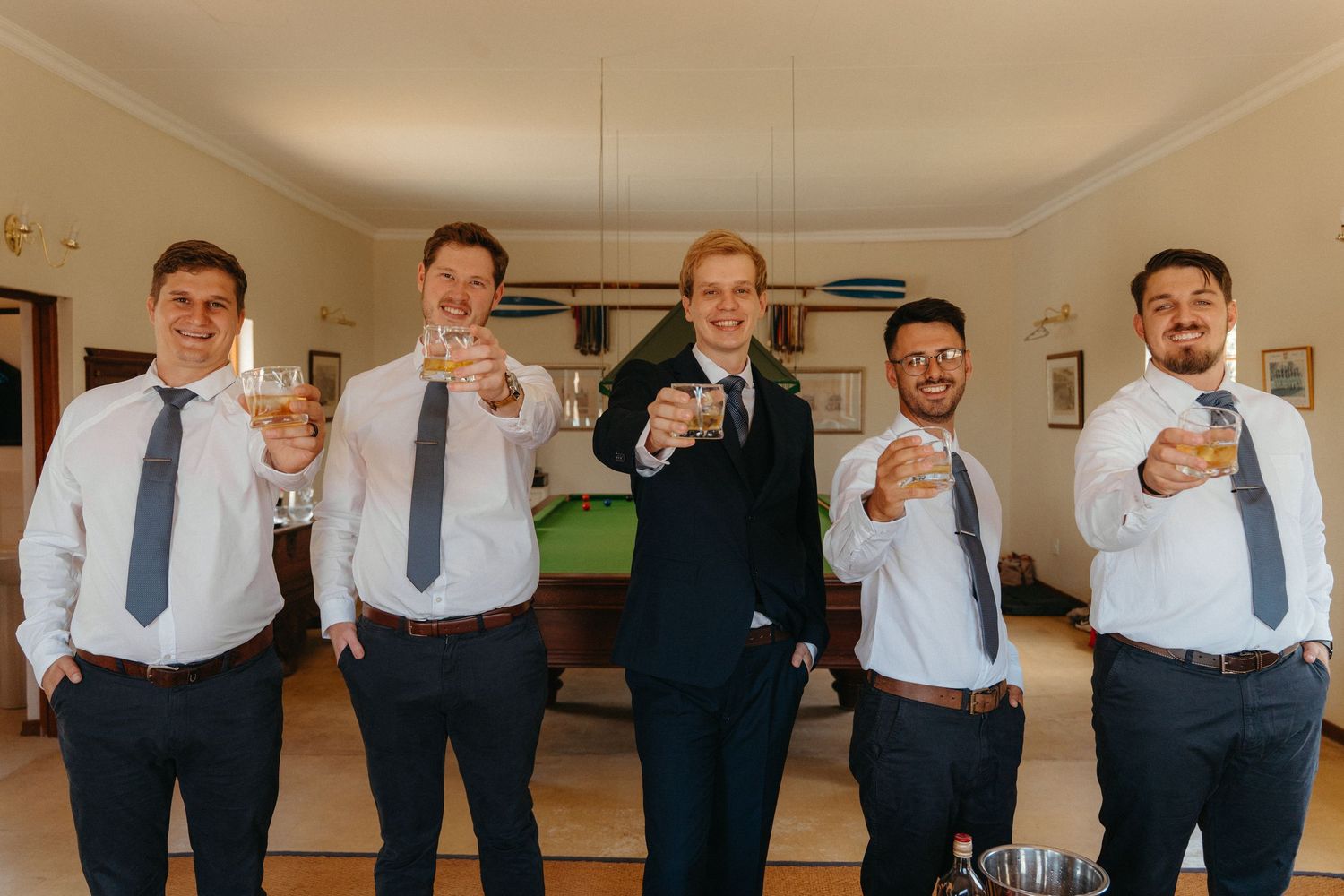 A group of groomsmen in white shirts and ties pose together in a candid sequence of fun photos.