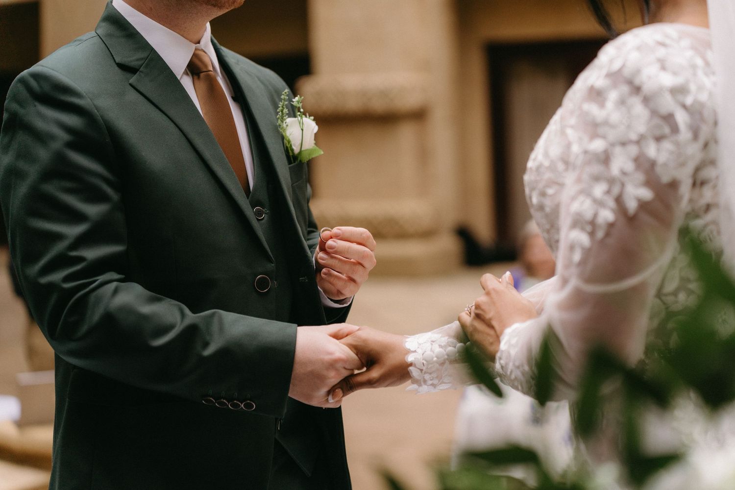 Close-up shot of a couple exchanging rings during their traditional wedding ceremony.
