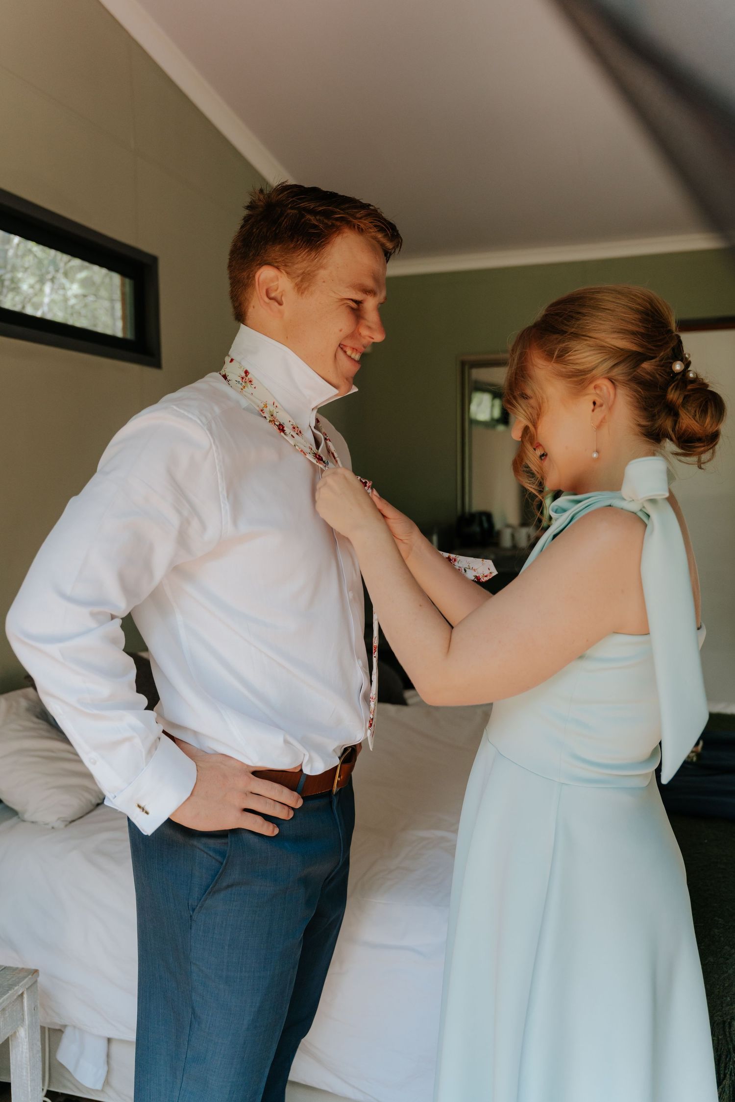 A couple in formal attire adjusts each other's outfits in a series of candid getting-ready photos.