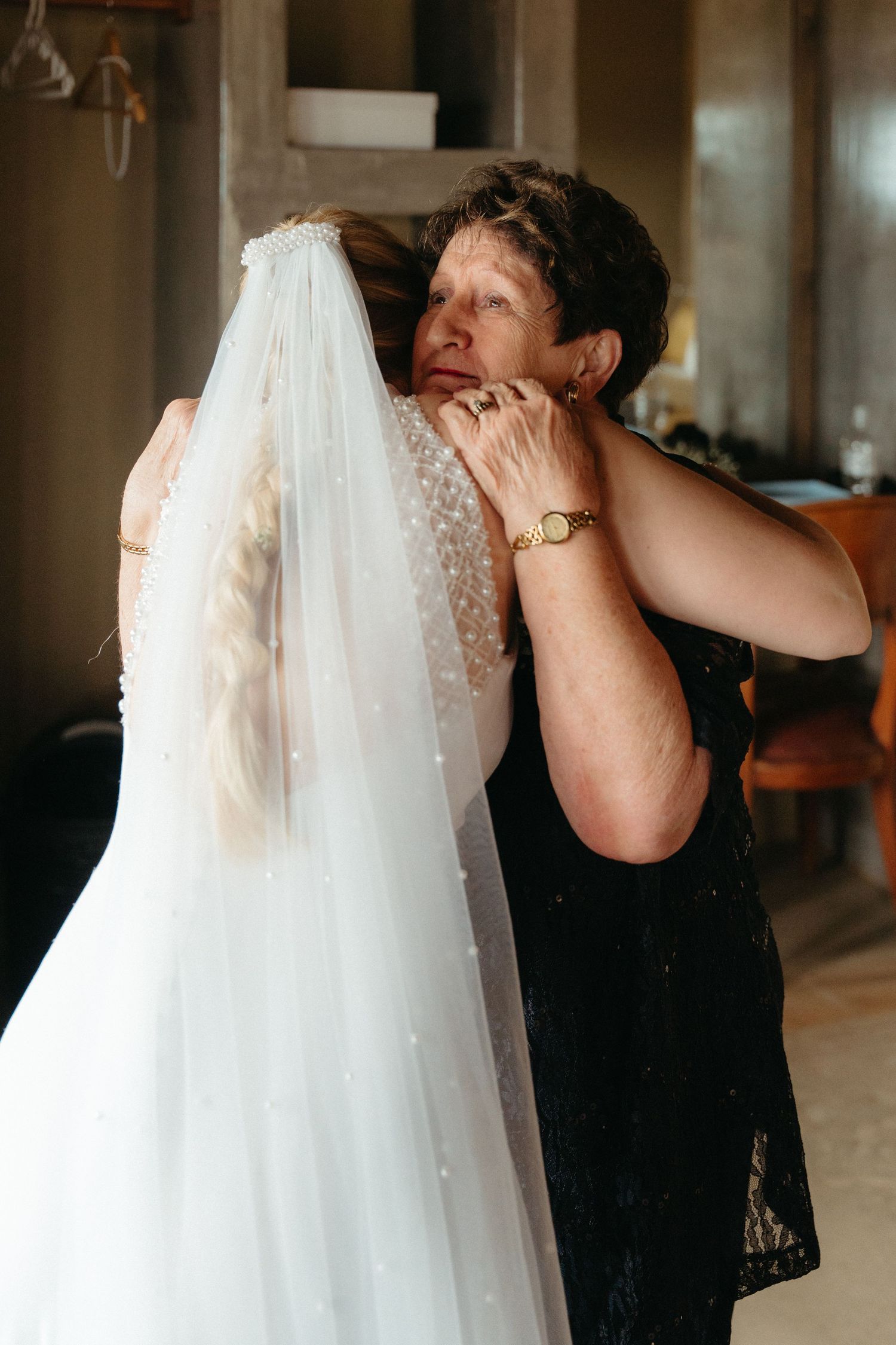 Wedding dress being prepared with delicate lace details and flowing fabric.