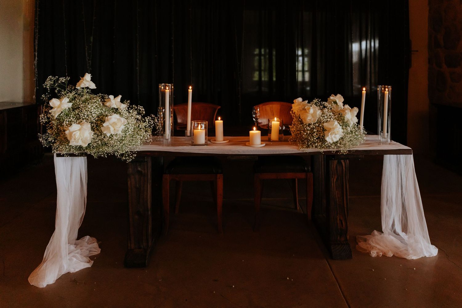 Mountain View Wedding reception venue decorated with white drapes and floral arrangements.