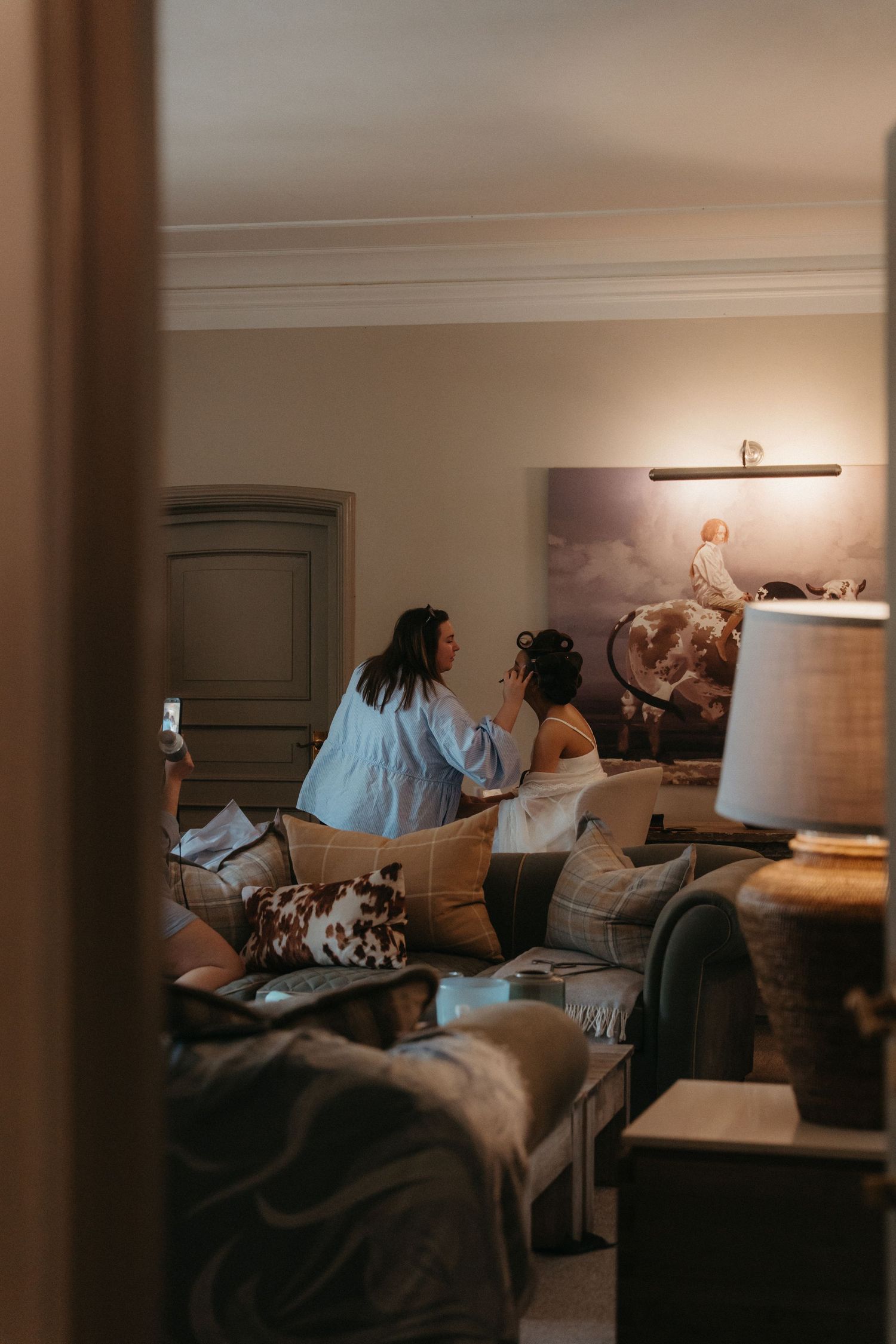 A makeup artist applying makeup to a bride at Beechwood Gardens before the wedding.