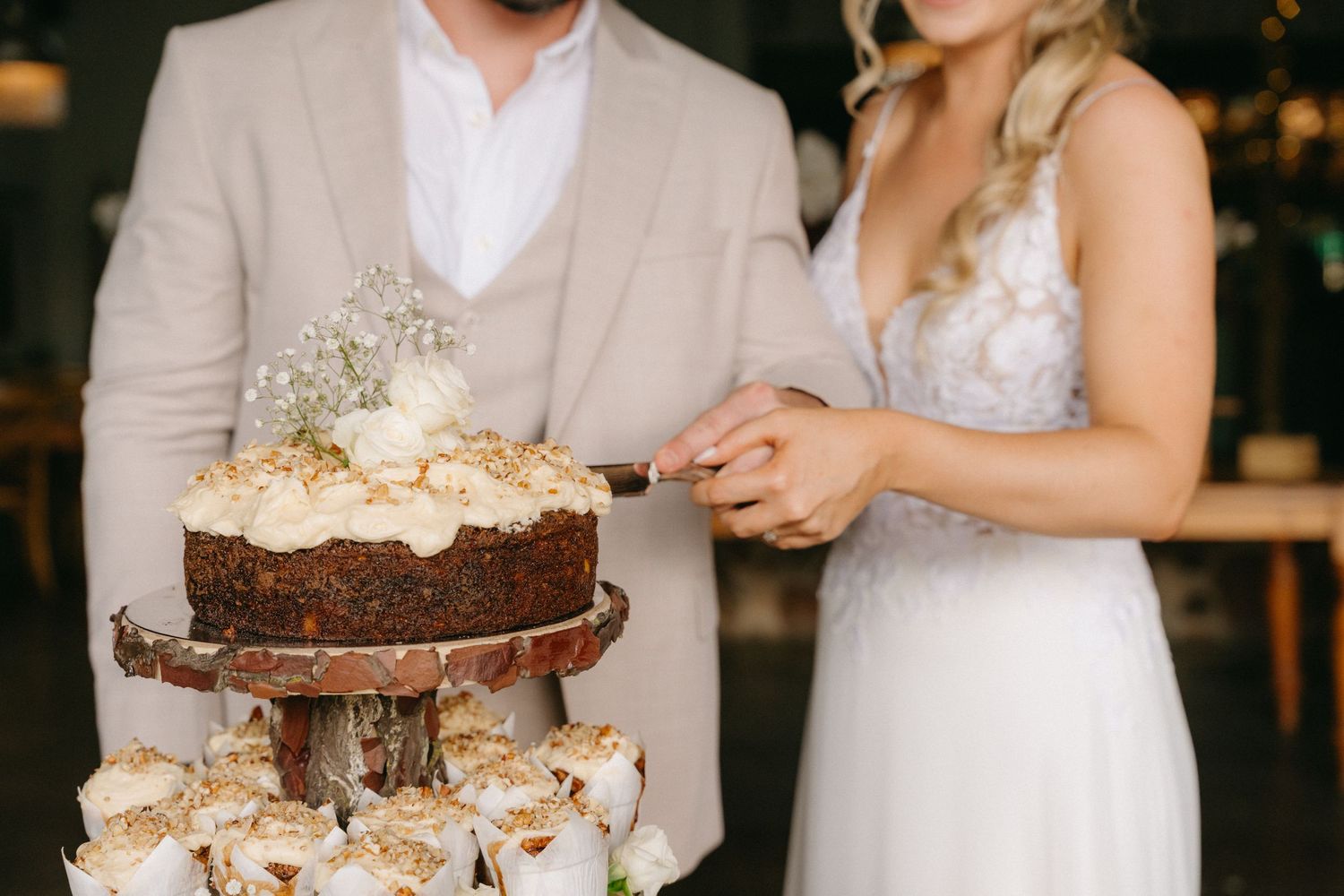 Wedding couple sharing sweet moments with desserts at their reception.