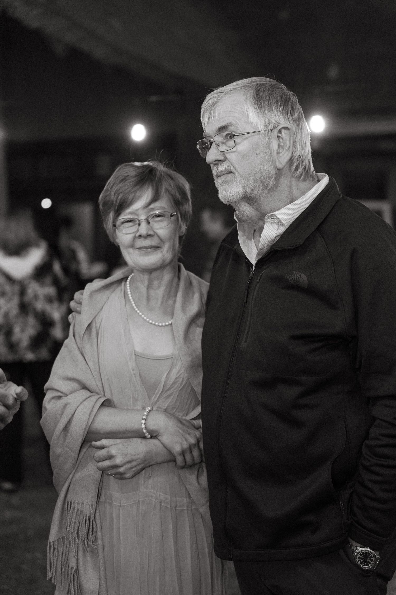 Elderly couple sharing an intimate dance moment at an evening reception.