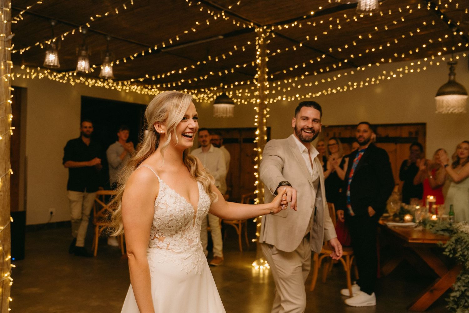 Wedding reception venue decorated with warm glowing string lights creating a romantic ambiance.