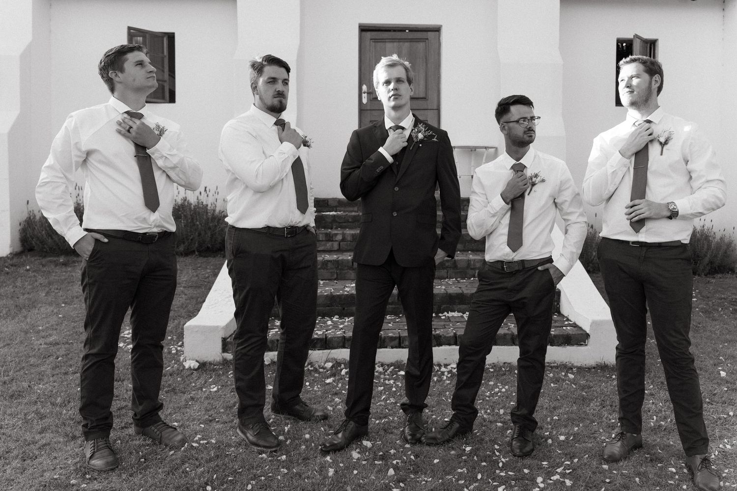 A sequence of black and white photos showing a group of men in formal attire dancing in synchronized steps.