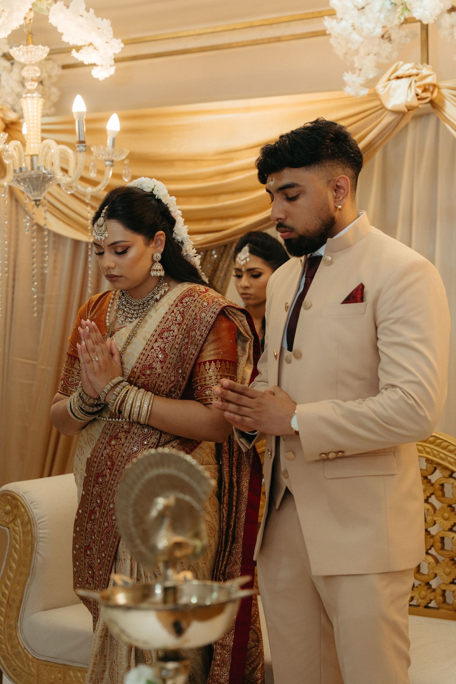 A traditional Indian wedding ceremony showing multiple moments of rituals and blessings in an elegantly decorated venue.