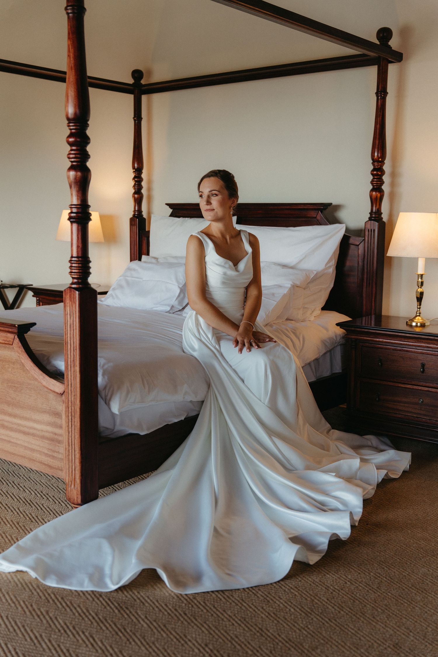 A series of five photos showing a white wedding dress flowing elegantly across a four-poster bed.