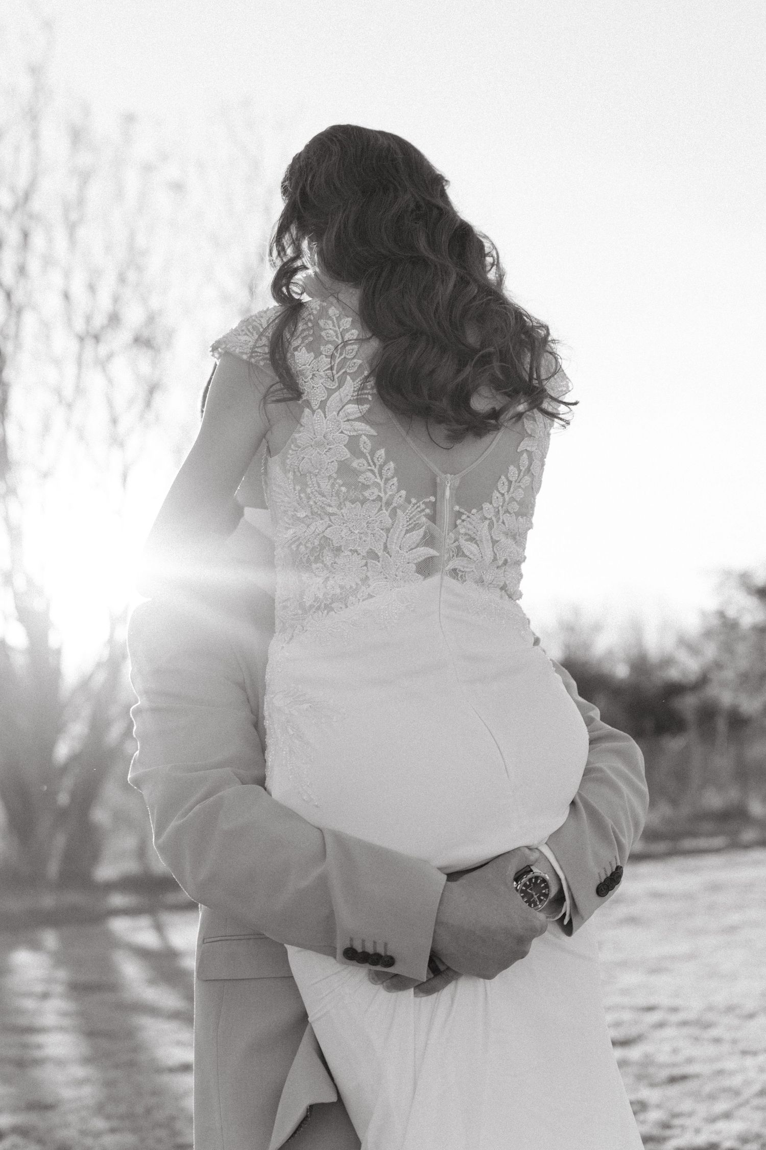 A romantic black and white photo sequence shows a couple embracing outdoors in sunlit winter scenery.