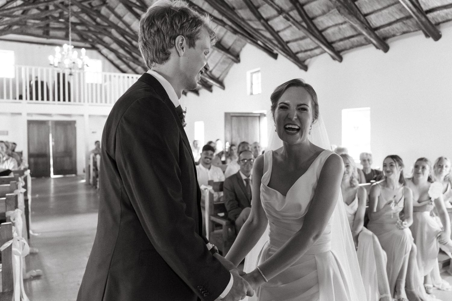Black and white wedding photos showing joyful moments between couples and guests during a reception celebration.