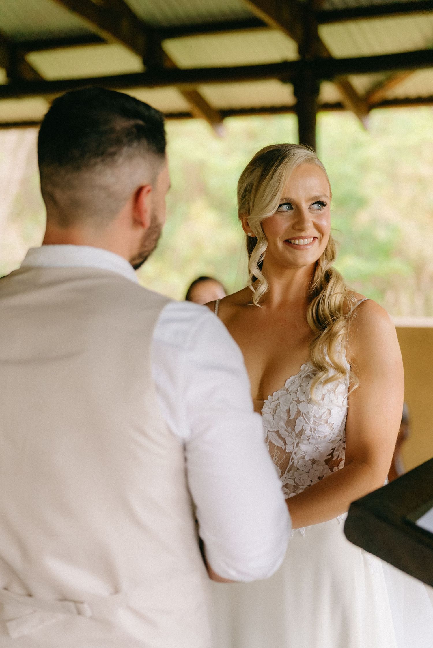 Intimate wedding moments captured in sequence under a covered outdoor venue.