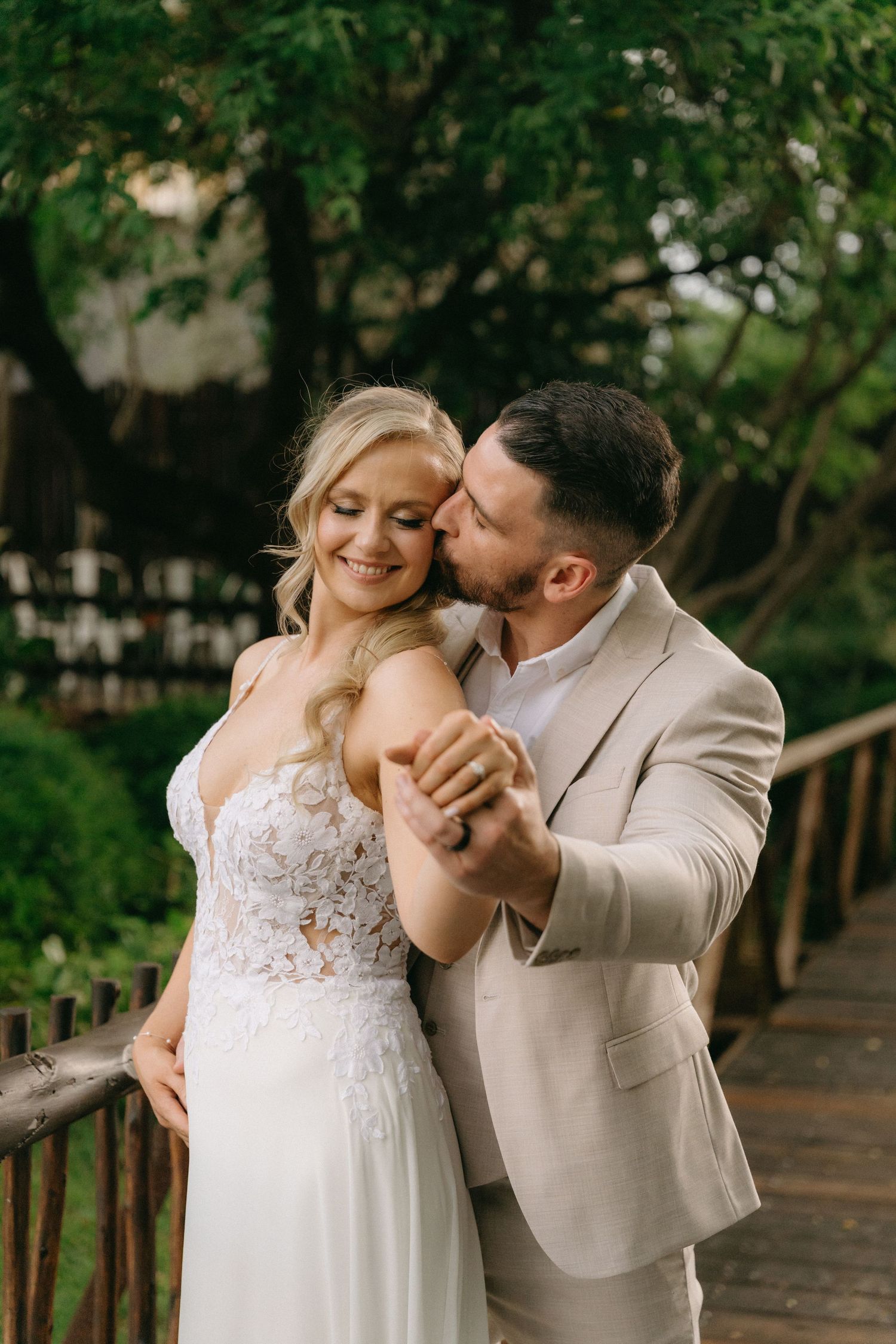 Romantic wedding couple shares tender moments during outdoor photo session.