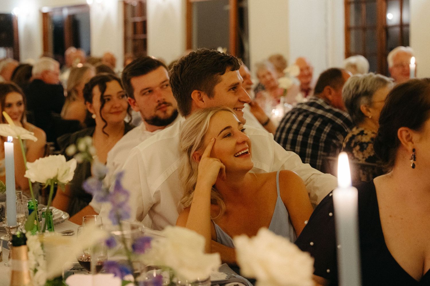Wedding reception guests enjoying a lively celebration in an elegant indoor venue.