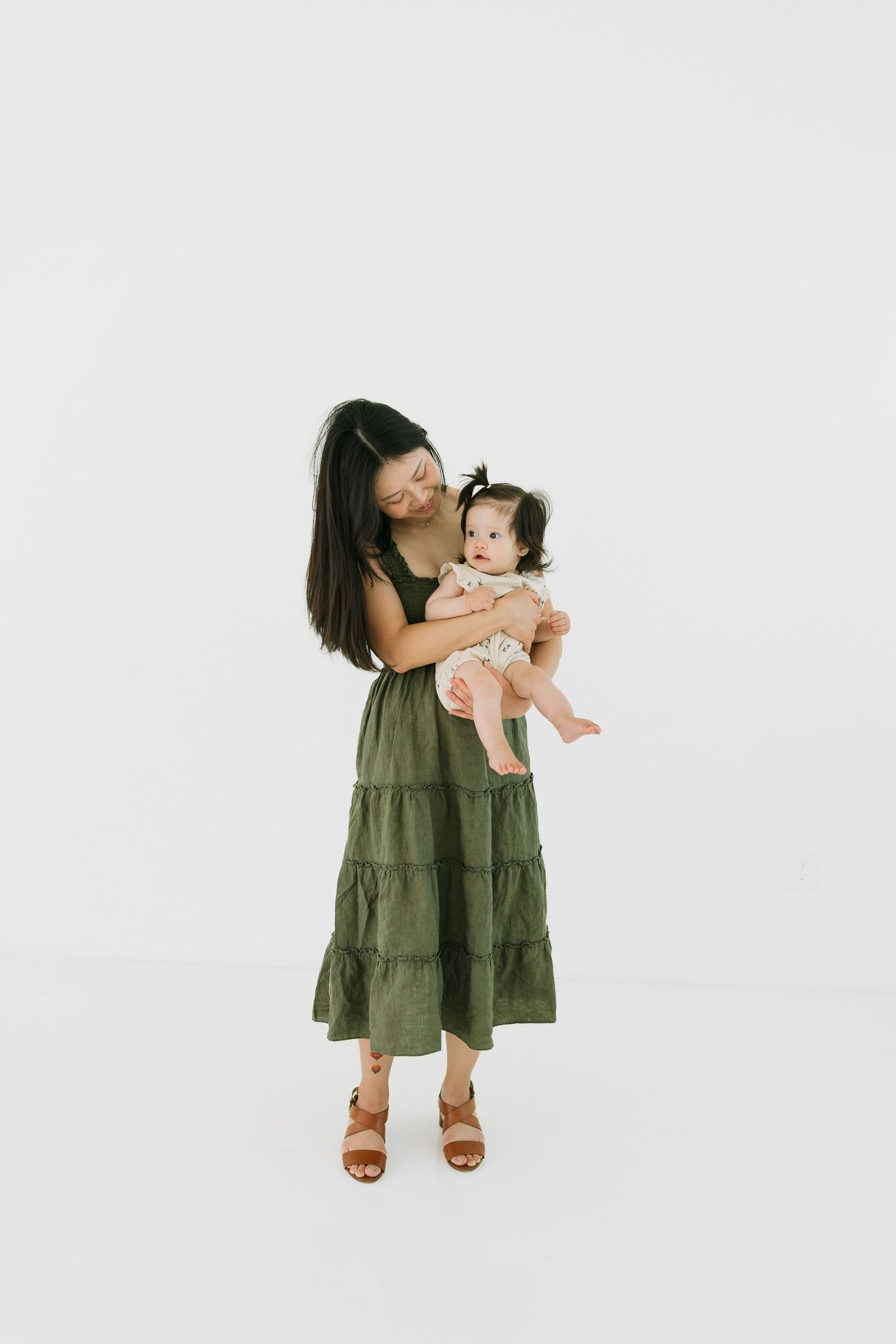 Mother embracing daughter in a bright studio location in AZ