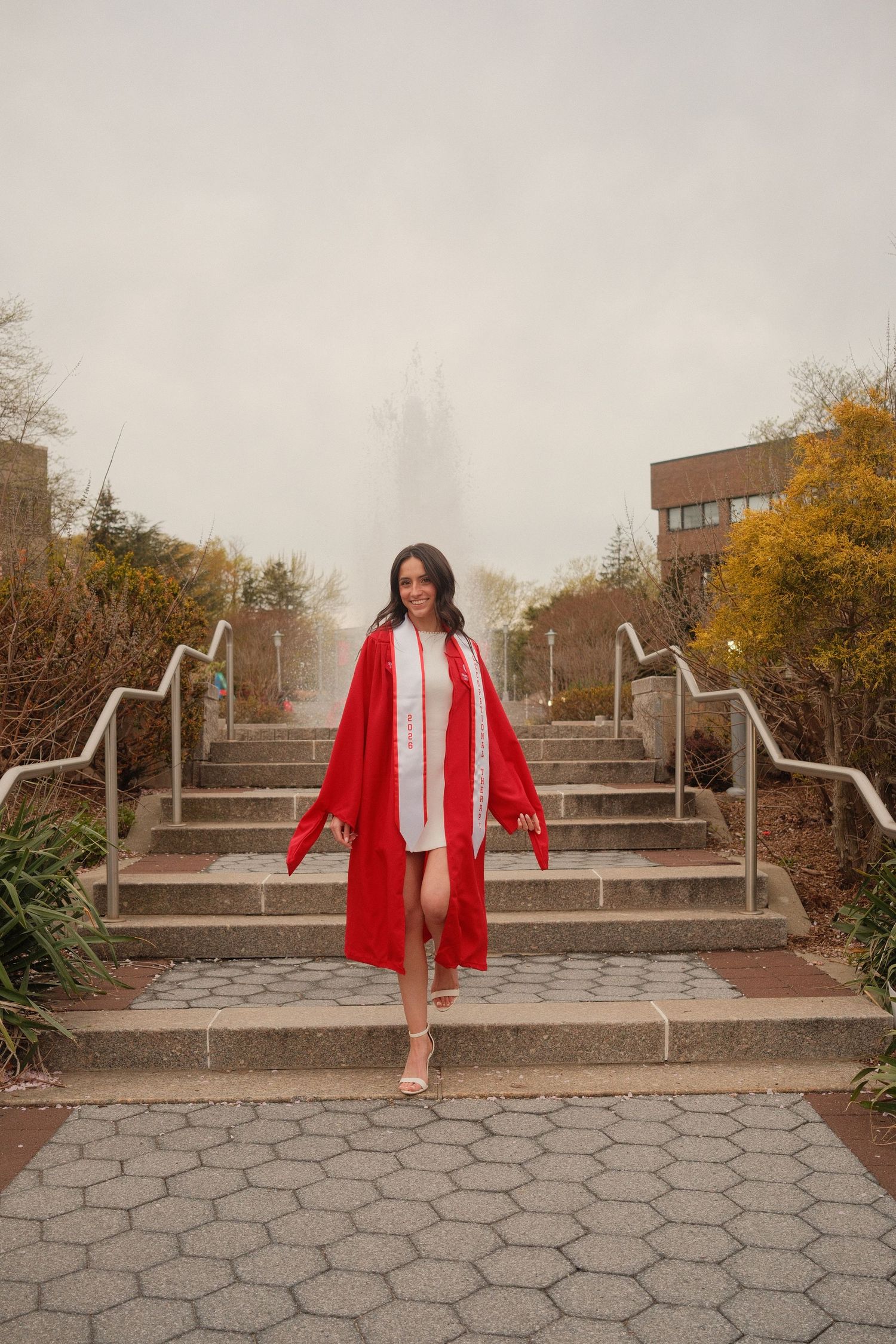 Graduate walking across campus during a film-inspired portrait session.