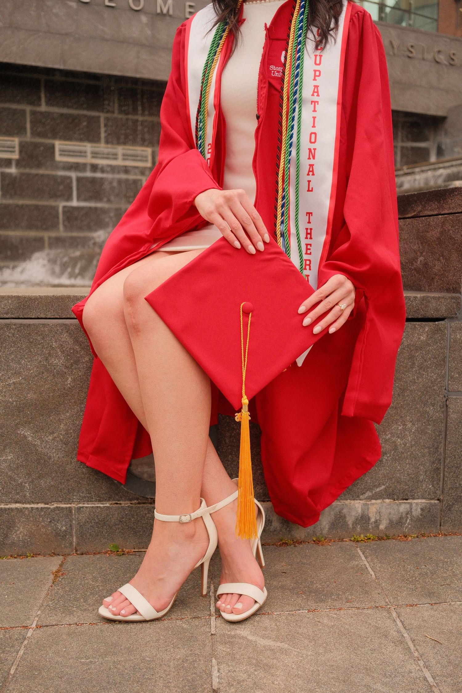 Close-up graduation detail capturing cap and gown textures and celebration details.