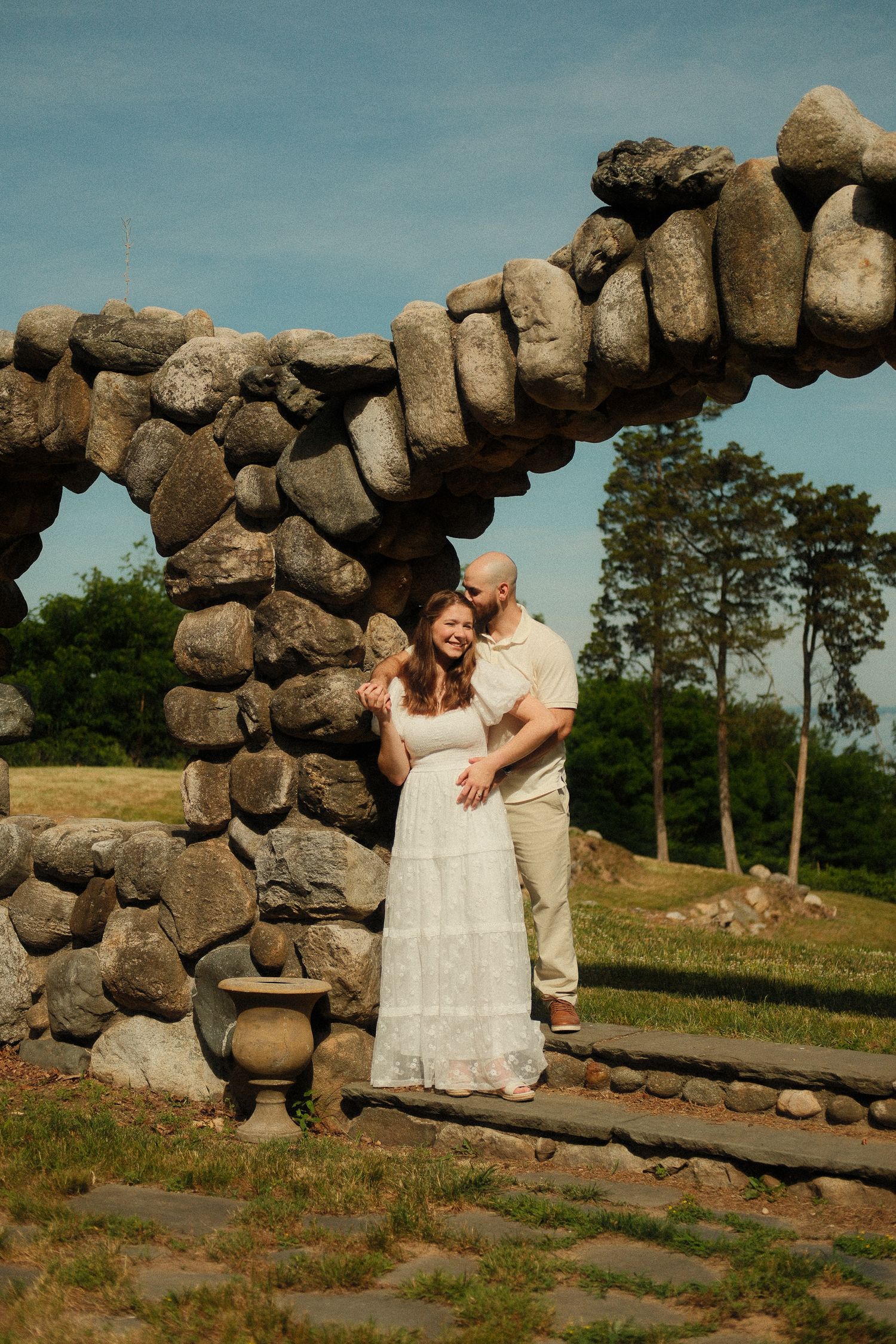Couple standing together during a relaxed engagement portrait session.