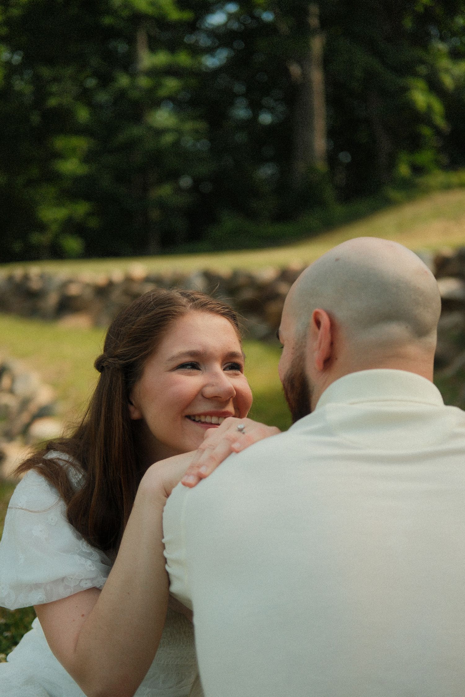 Close-up engagement portrait focusing on natural emotion and connection.