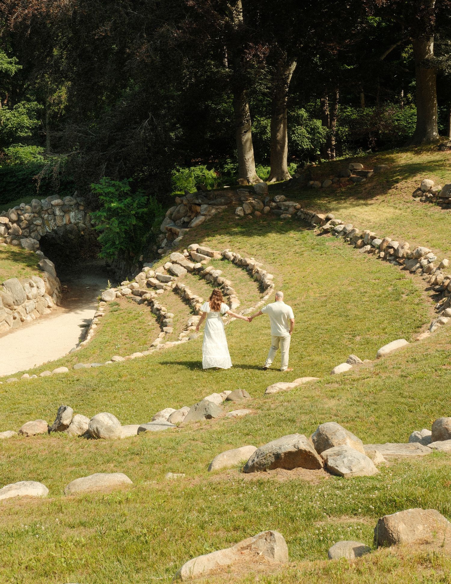 Couple walking together during a candid engagement session outdoors.