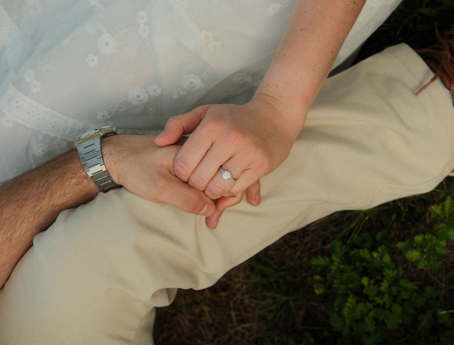 Romantic detail shot of hands and rings during an engagement session.