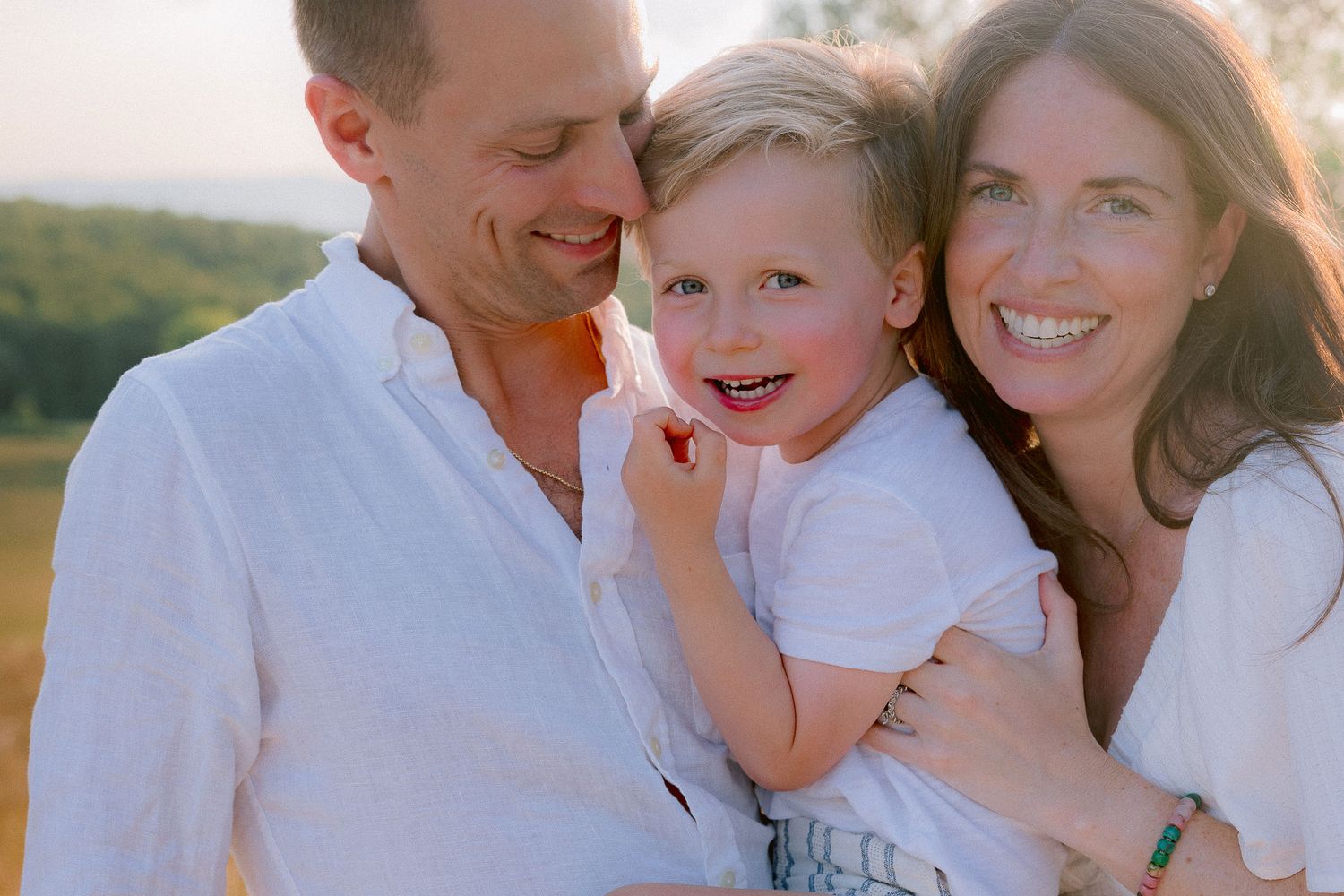 Candid family moments captured in a series of joyful outdoor portraits.