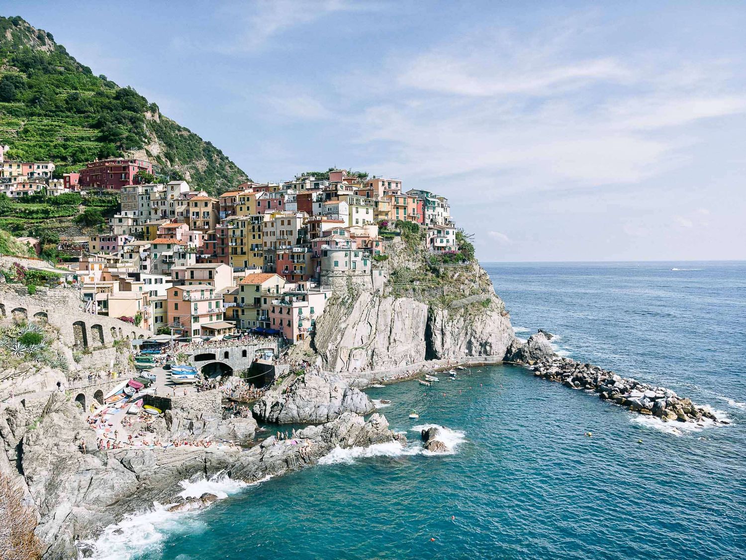 Cinque Terre village perched on dramatic cliffs overlooking the Mediterranean Sea.