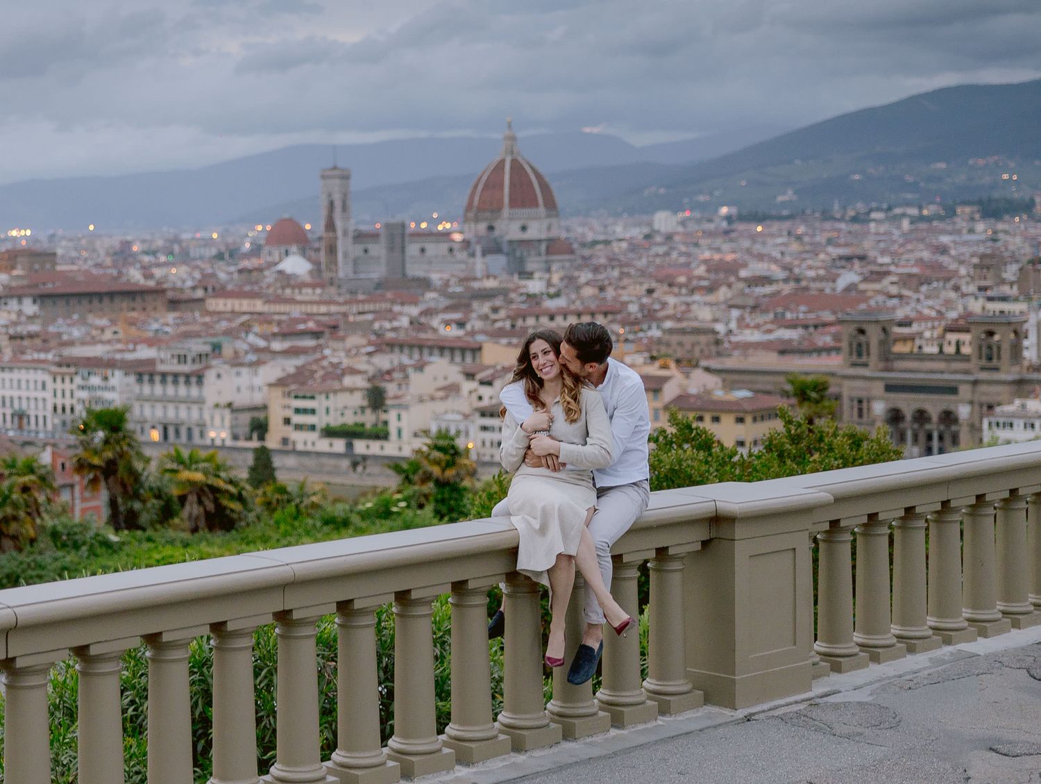 Panoramic view of Florence's historic skyline with the Duomo cathedral visible against cloudy skies.