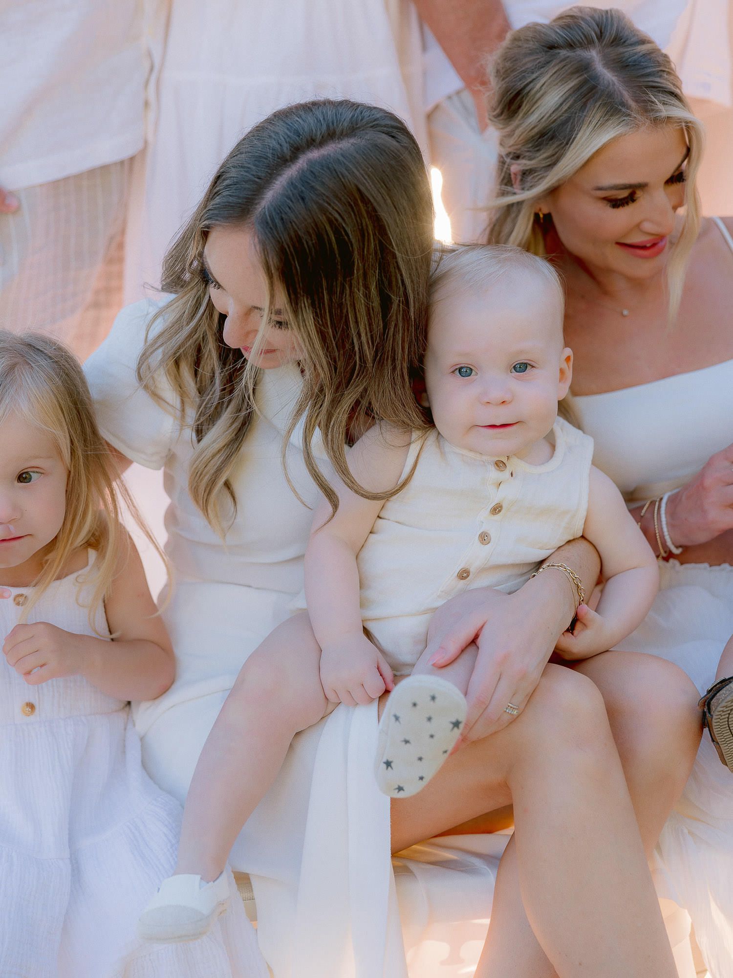 Sweet moment with little ones in white summer dresses.