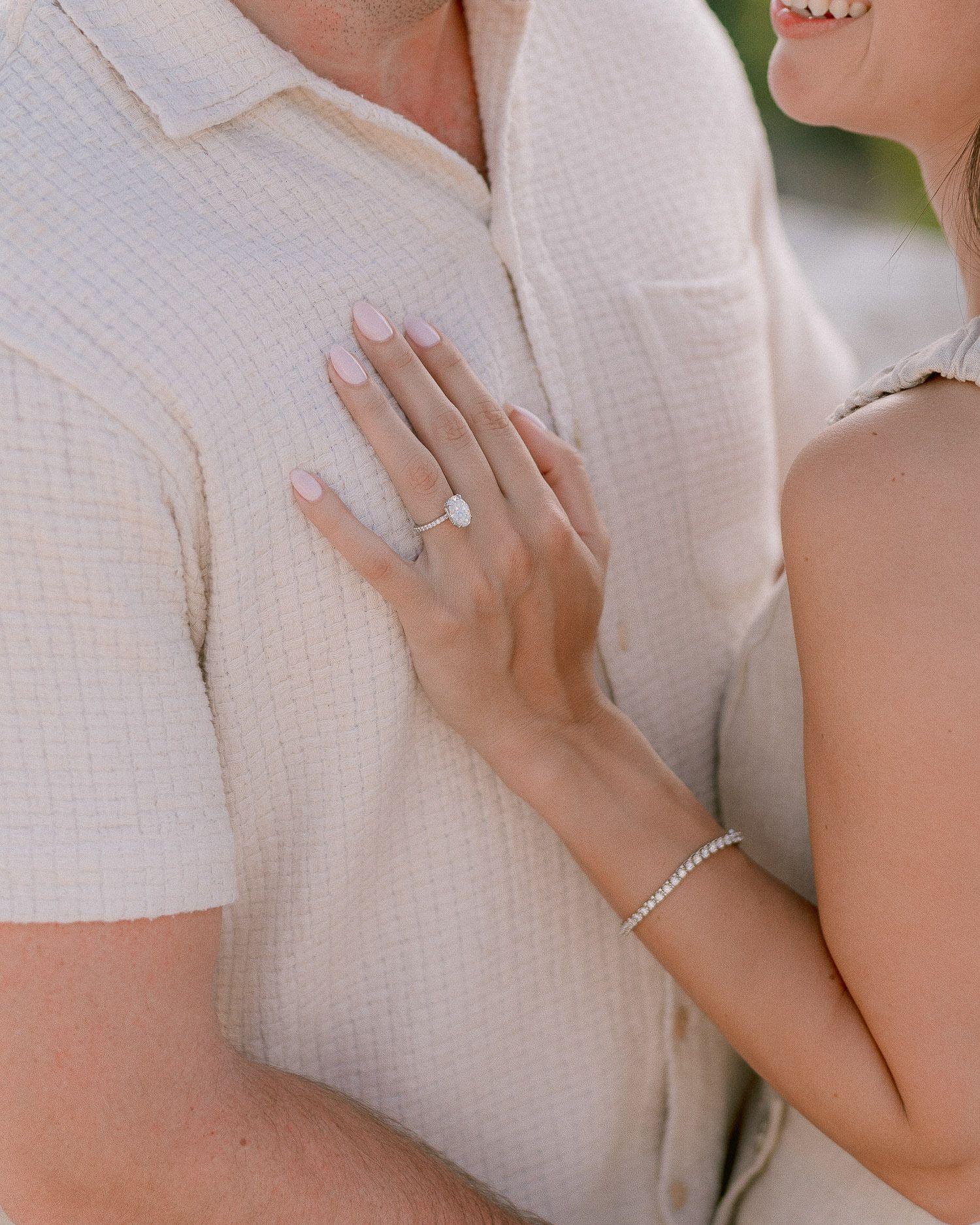 Close-up shot showing a newly engaged couple's joyful embrace.
