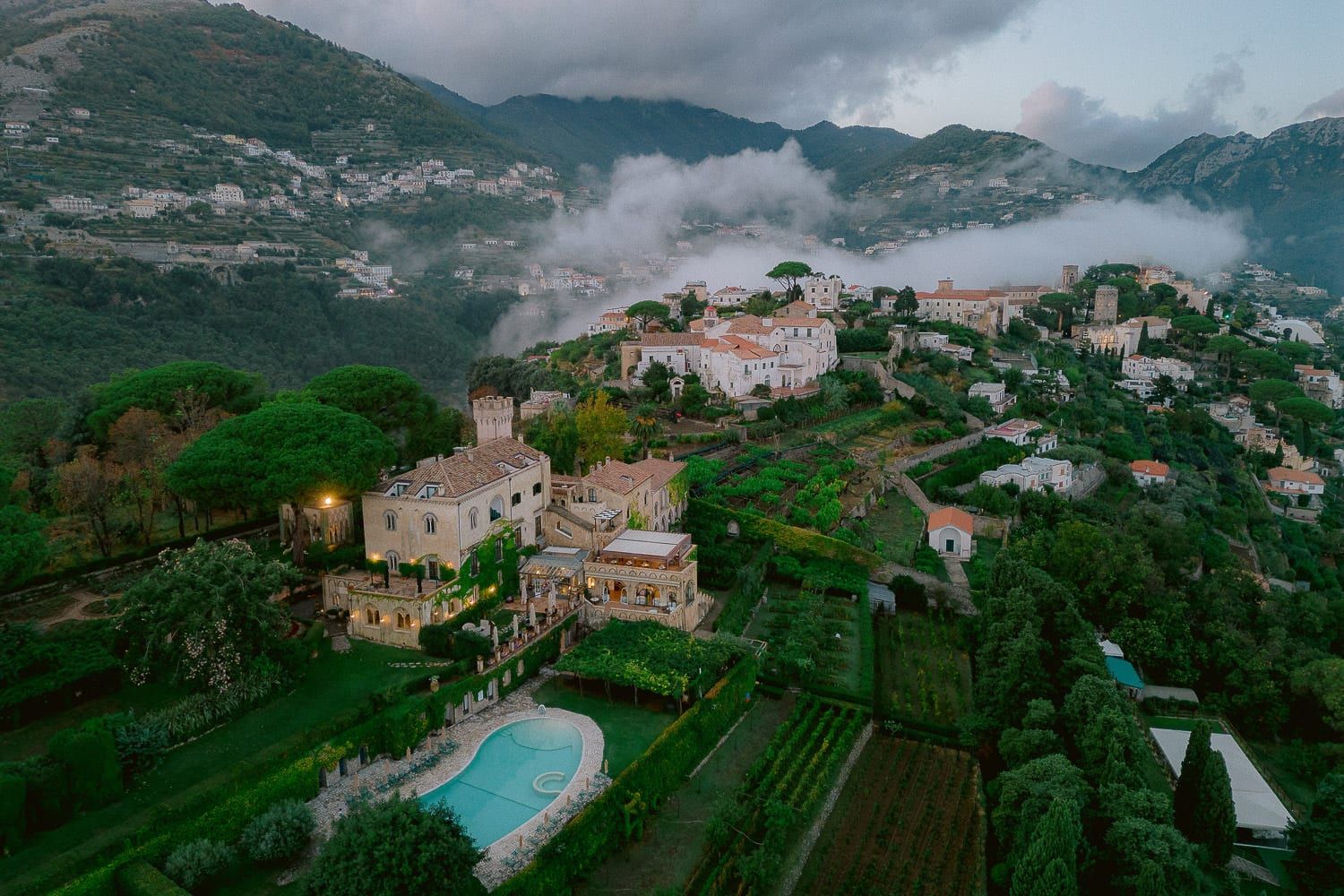 Panoramic view of hillside villas and terraced gardens along the Amalfi Coast.