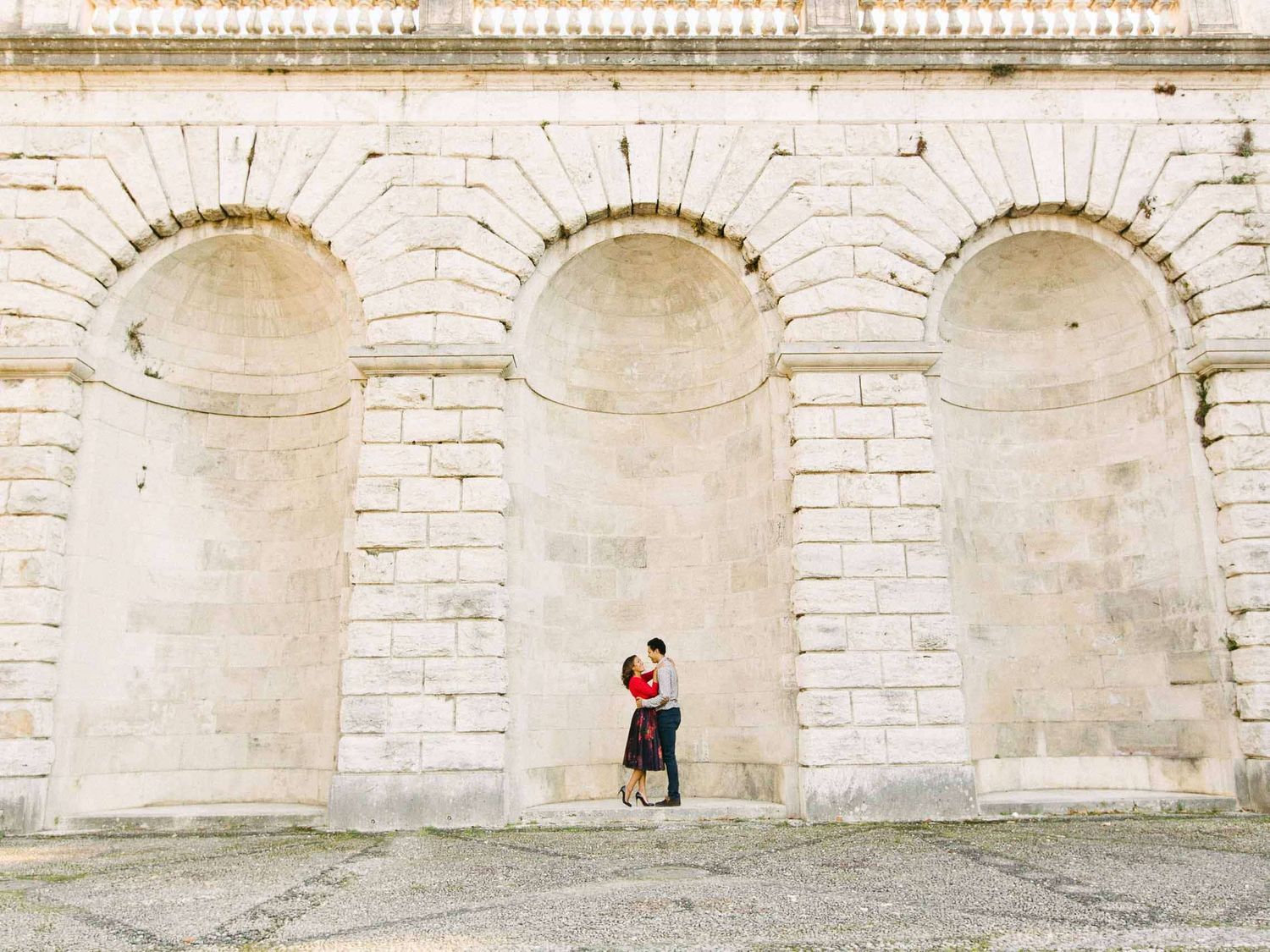 Elegant stone archways create perfect framing for romantic portraits.