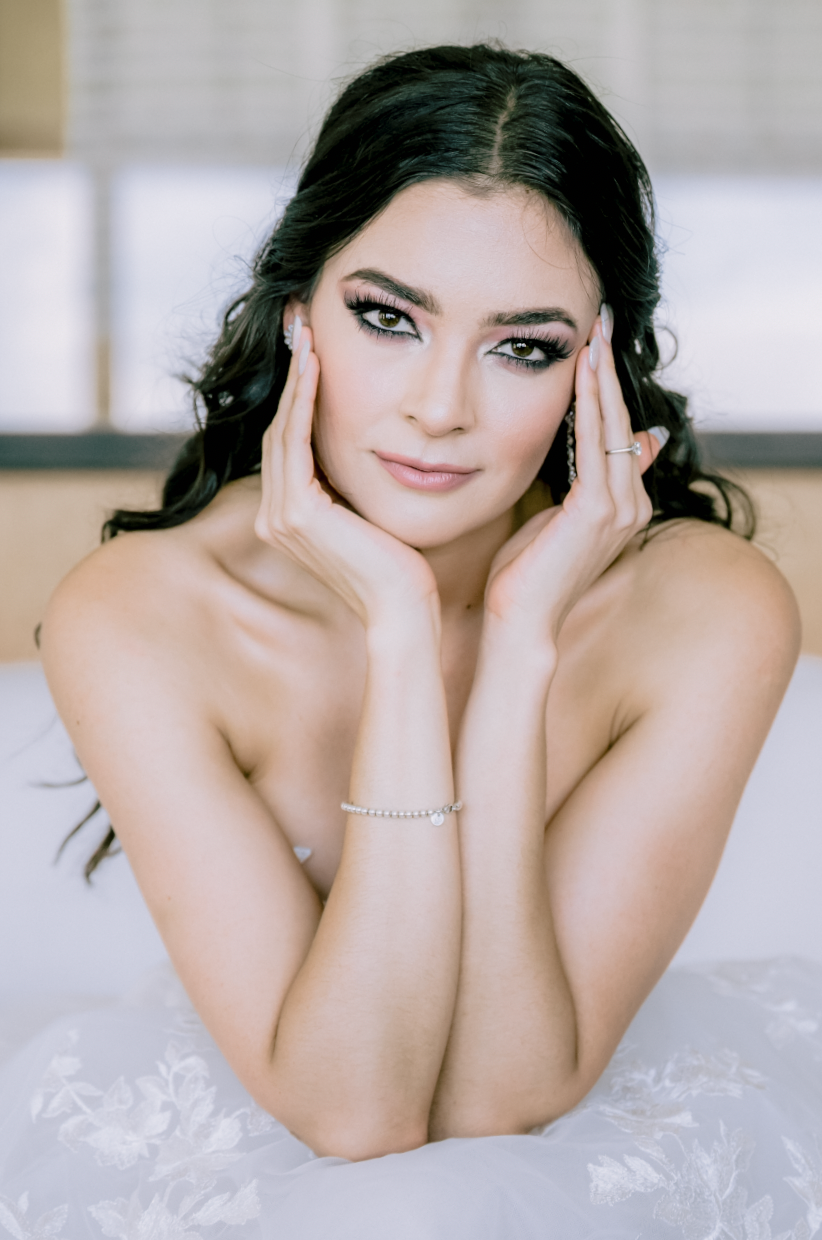 Intimate bridal boudoir photo with soft lighting and romantic pose.
