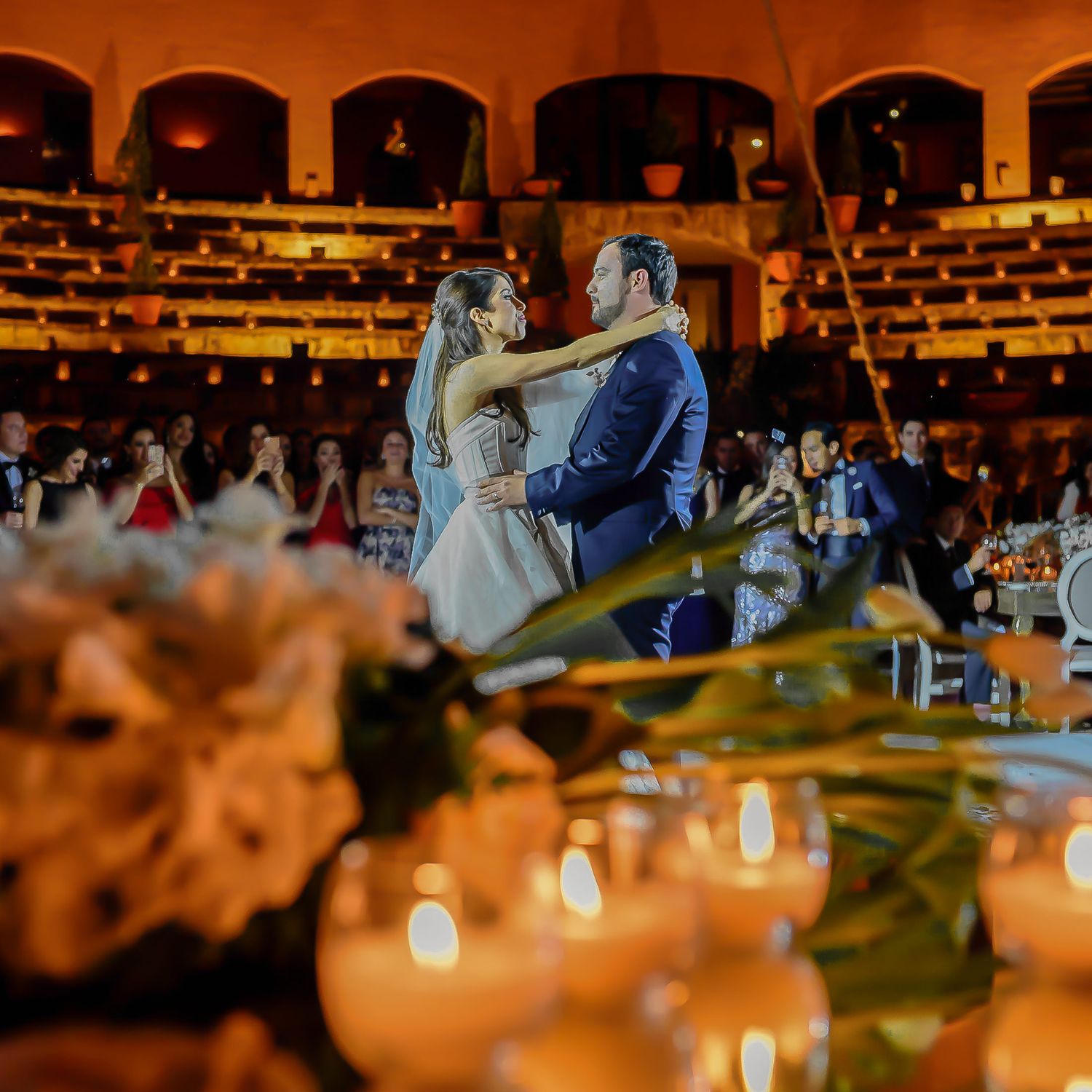 Elegant wedding reception venue with warm lighting and floral decor creates a romantic atmosphere.