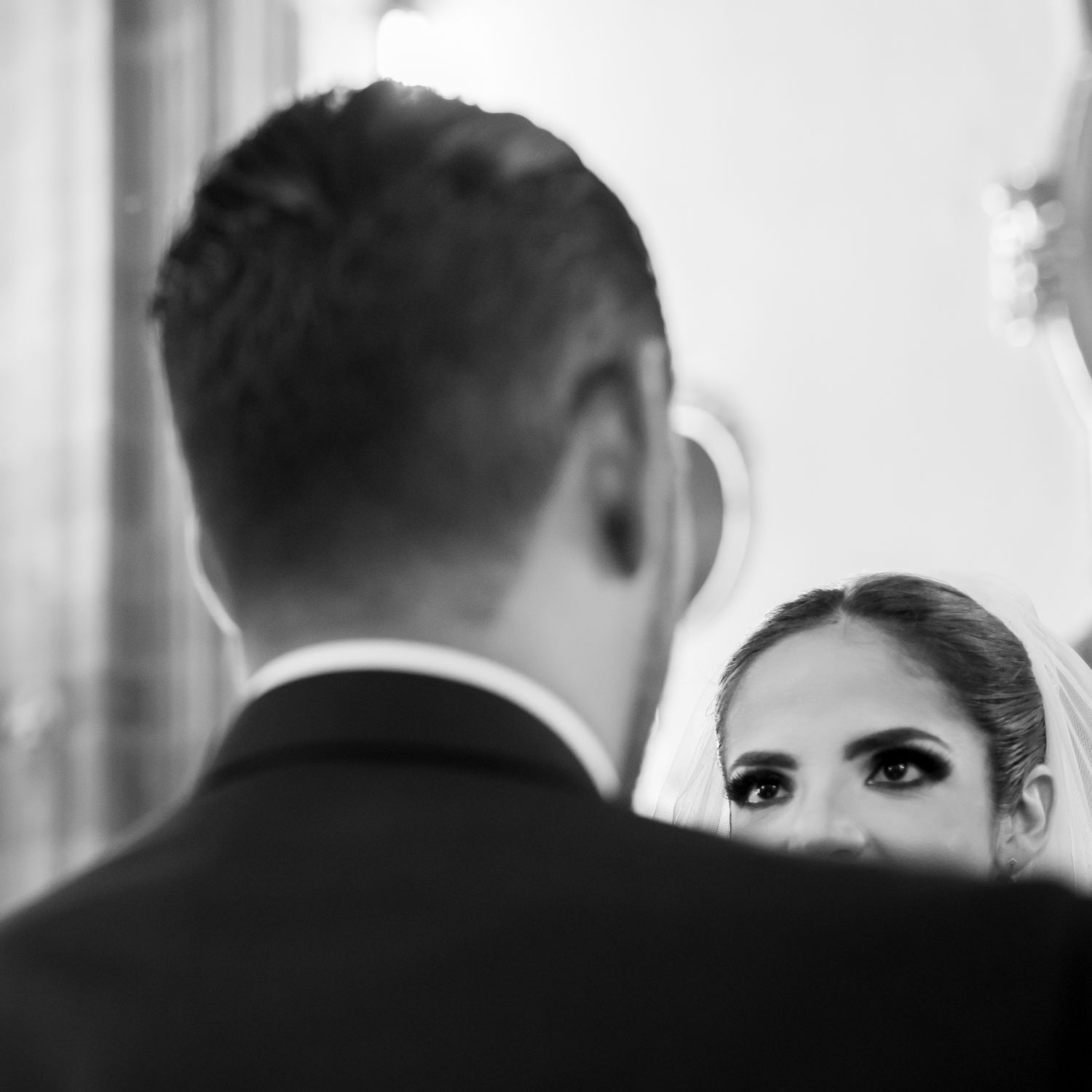 Artistic black and white close-up shot capturing an intimate wedding moment.