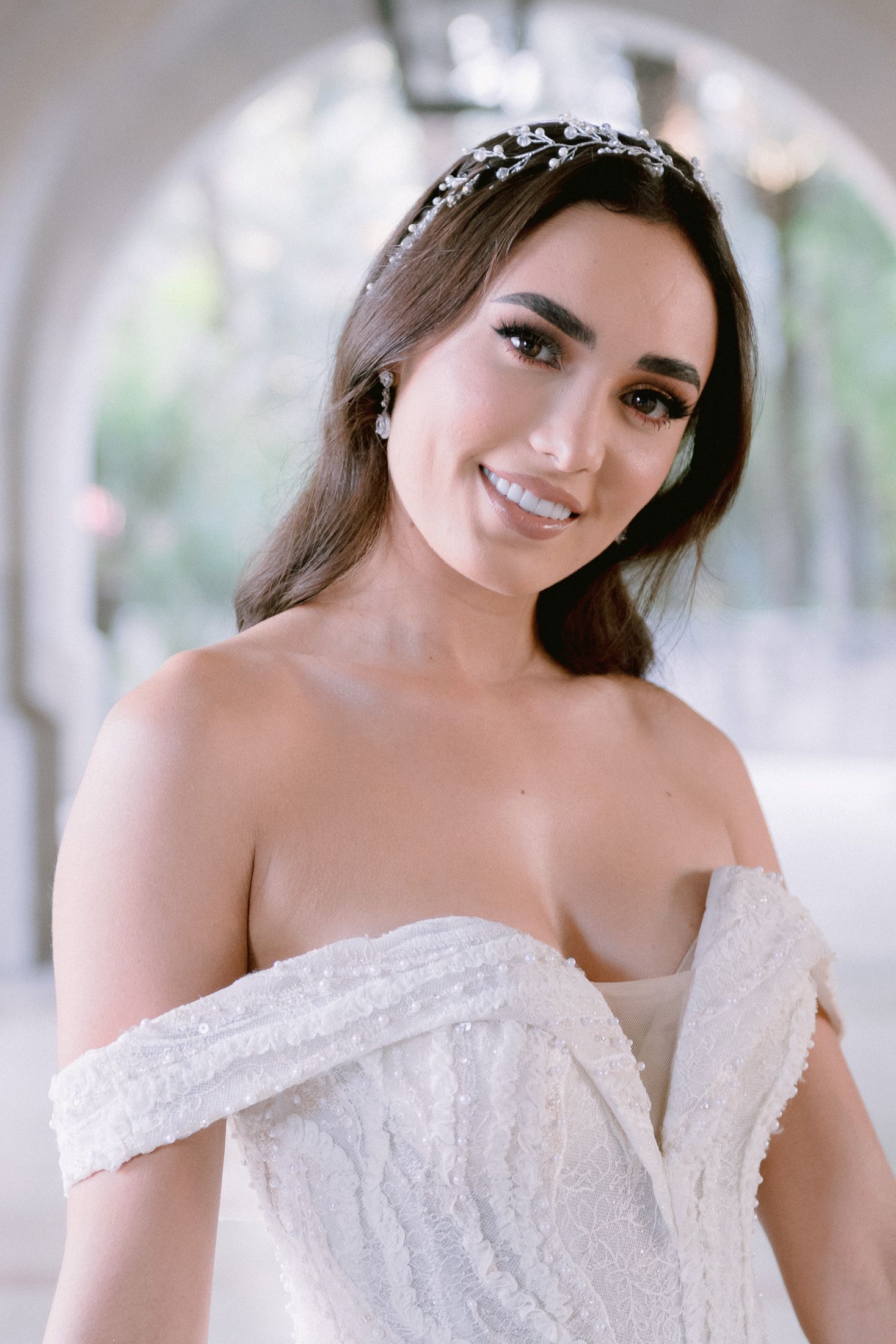 Elegant bridal portraits featuring an off-shoulder white lace wedding gown.