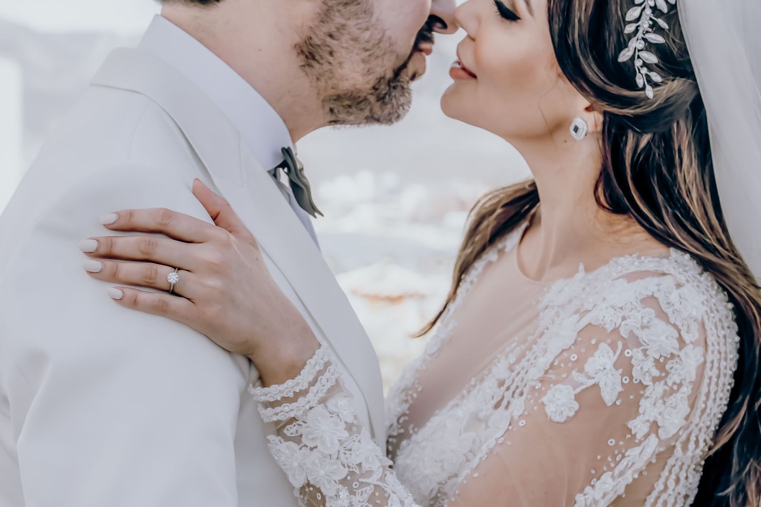 Romantic wedding couple shares an intimate moment in a dreamy outdoor setting with soft lighting.