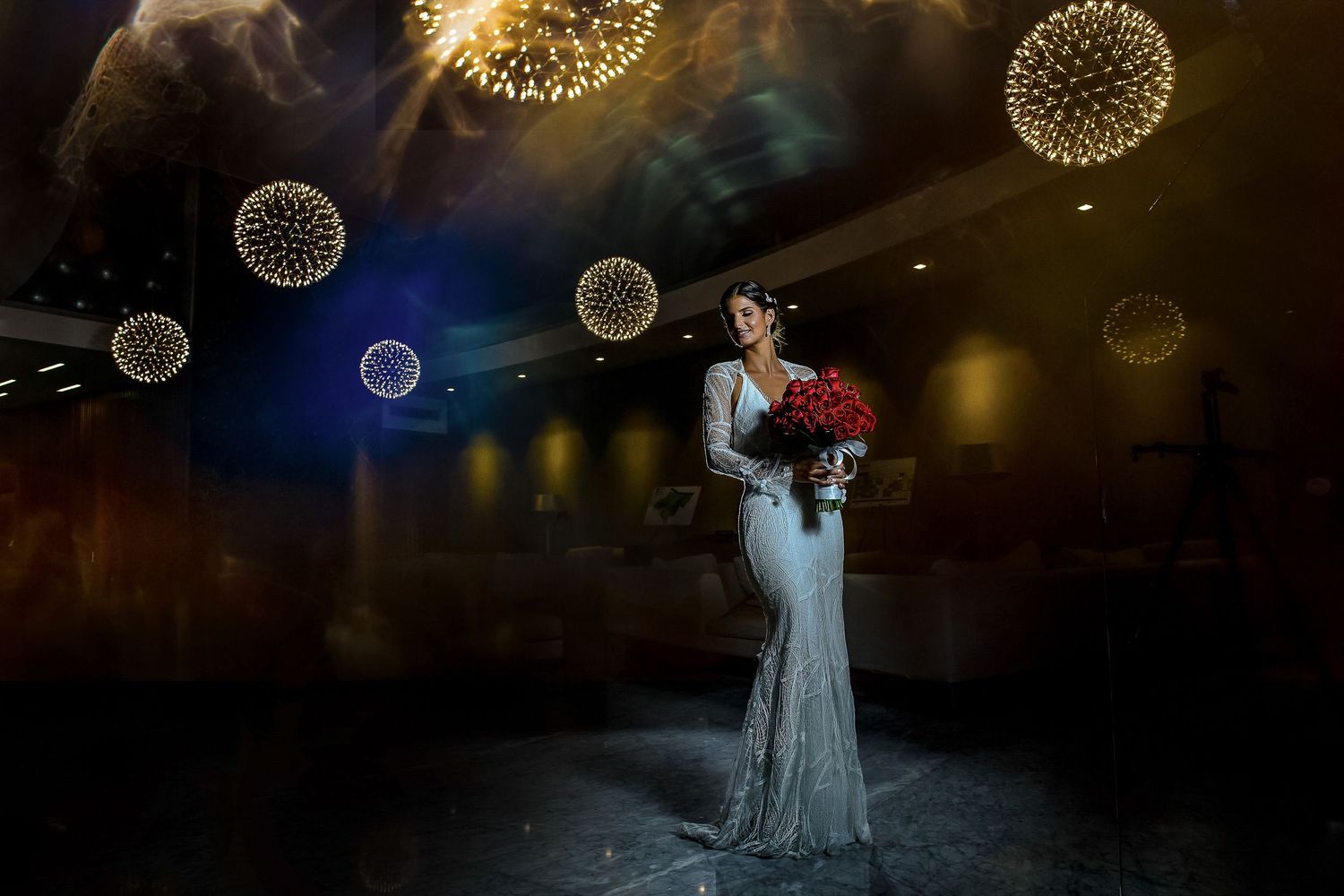 Wedding portraits under glowing spherical lights creating a magical nighttime atmosphere.