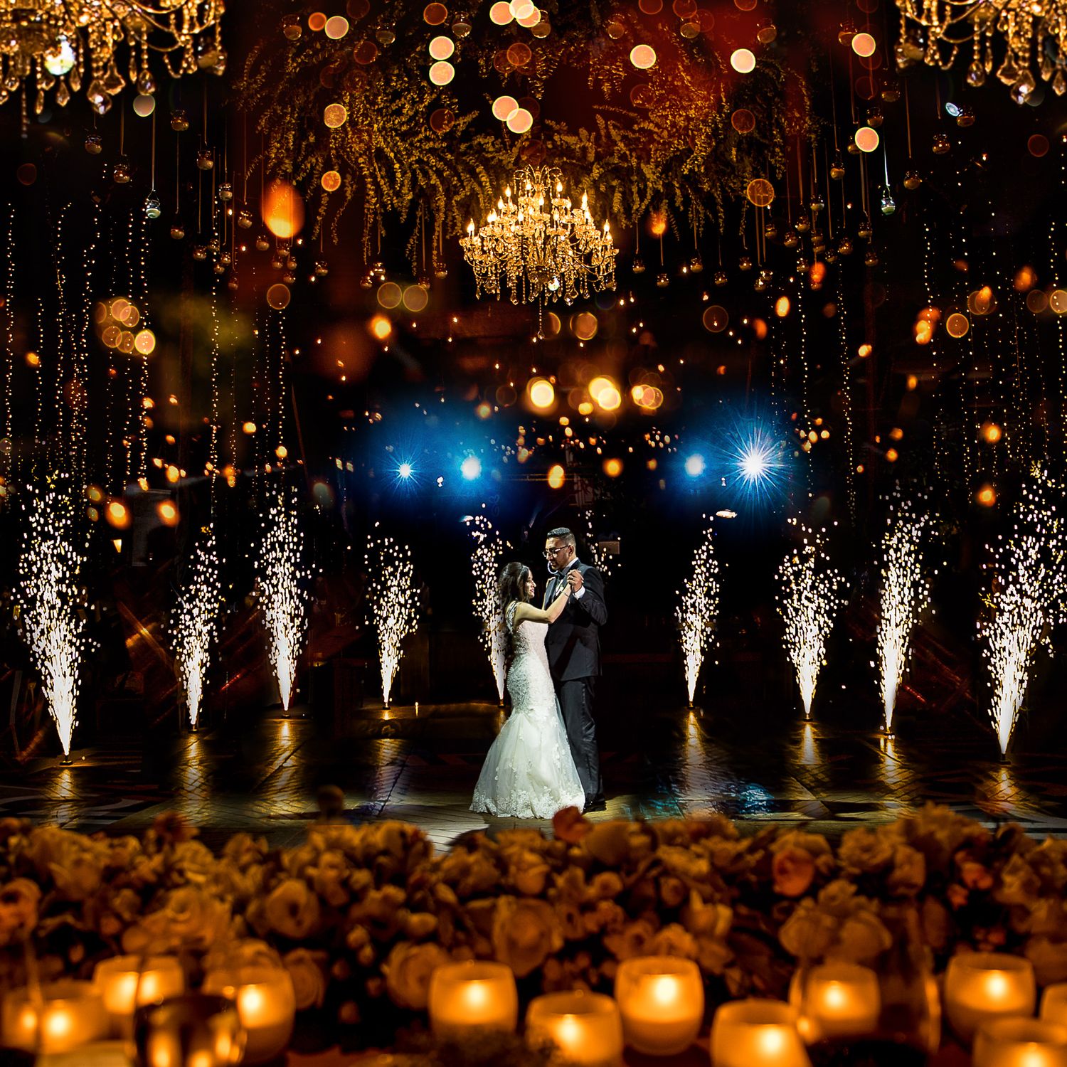 Spectacular wedding celebration with pyrotechnic fountains and glowing lanterns creating a magical atmosphere.