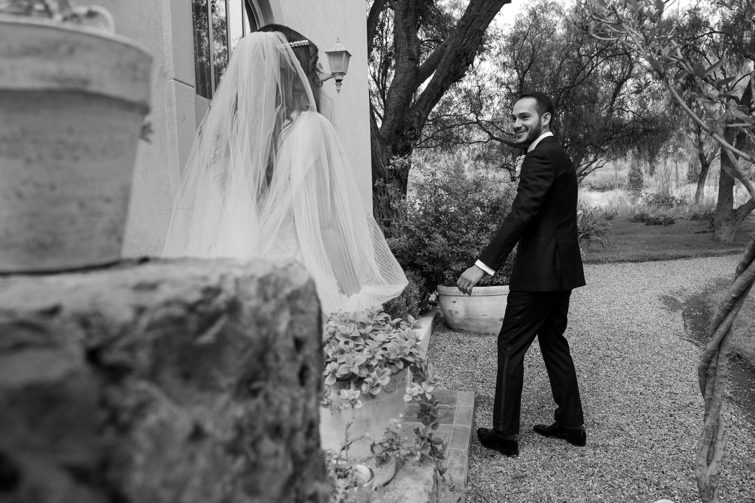 Black and white wedding photos show couples dancing and embracing in an outdoor garden setting.