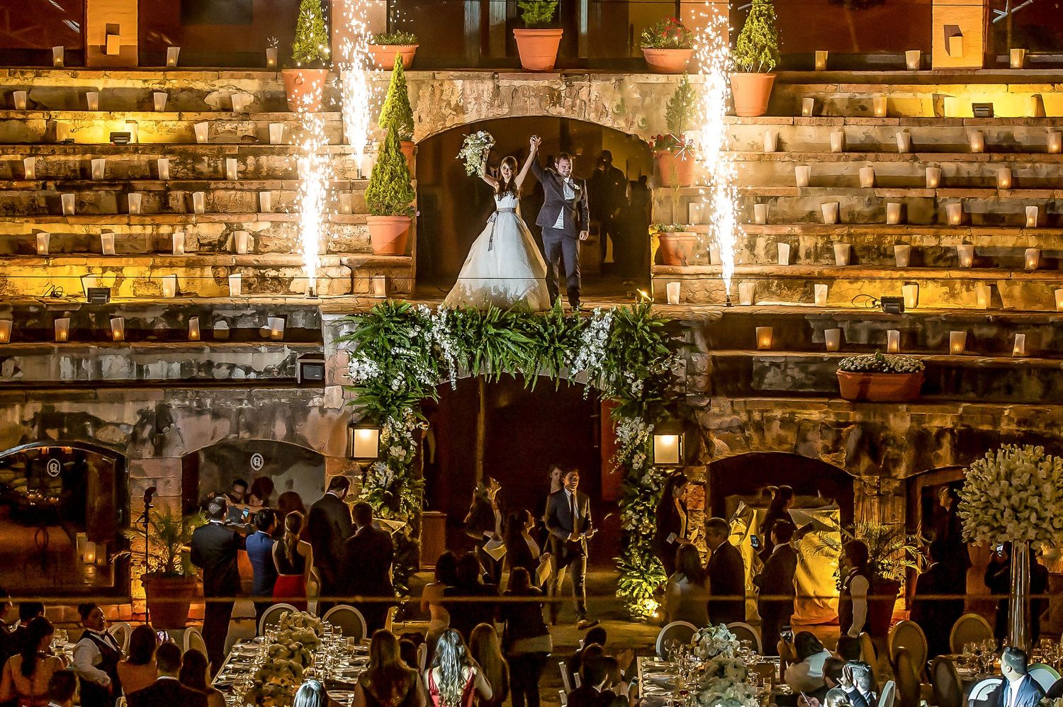 Reception venue with exposed brick walls and warm lighting creating rustic ambiance.